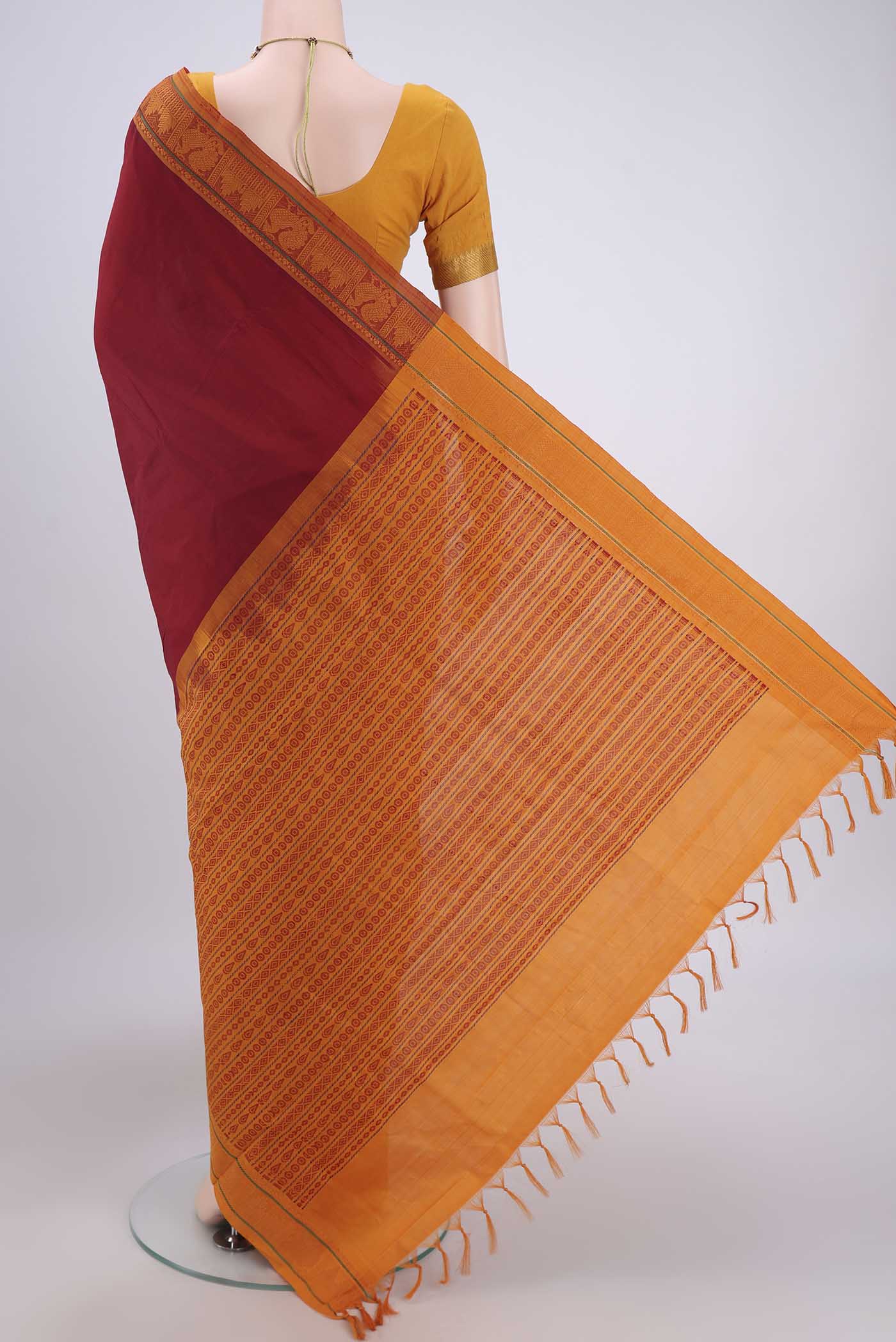 Flat view of Maroon Blended Poly Cotton Saree with Plain Body and Thread Border. 
