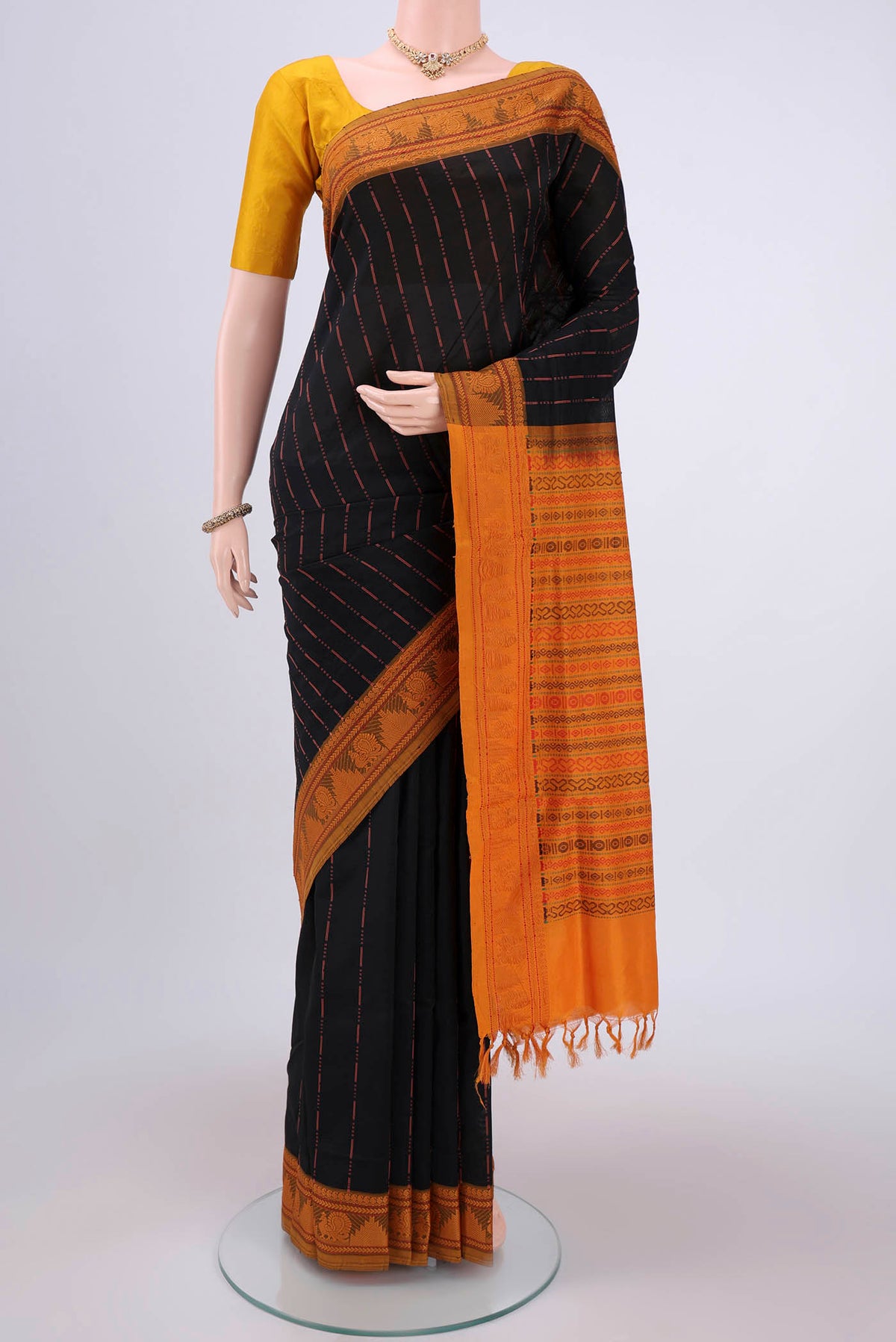 Black Blended Poly Cotton Saree with Stripes on the body and Thread Border.  displayed on a mannequin