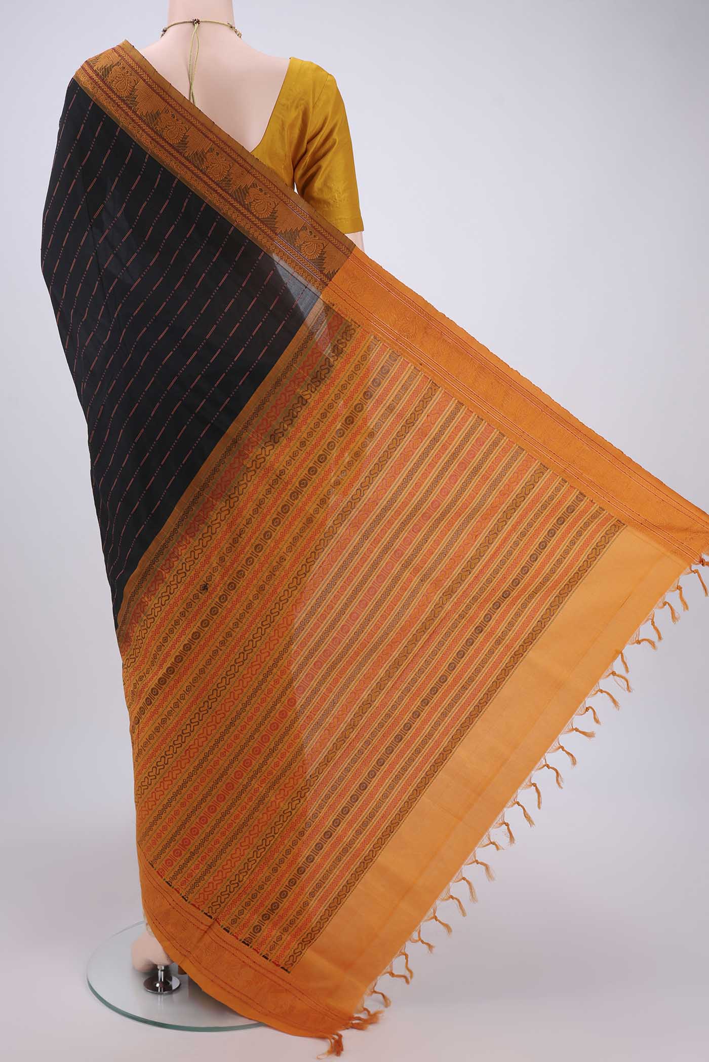 Flat view of Black Blended Poly Cotton Saree with Stripes on the body and Thread Border. 