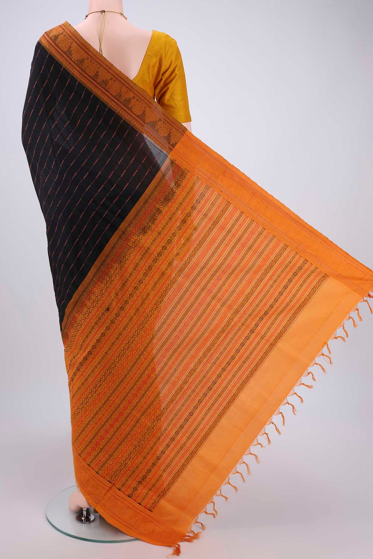 Flat view of Black Blended Poly Cotton Saree with Stripes on the body and Thread Border. 
