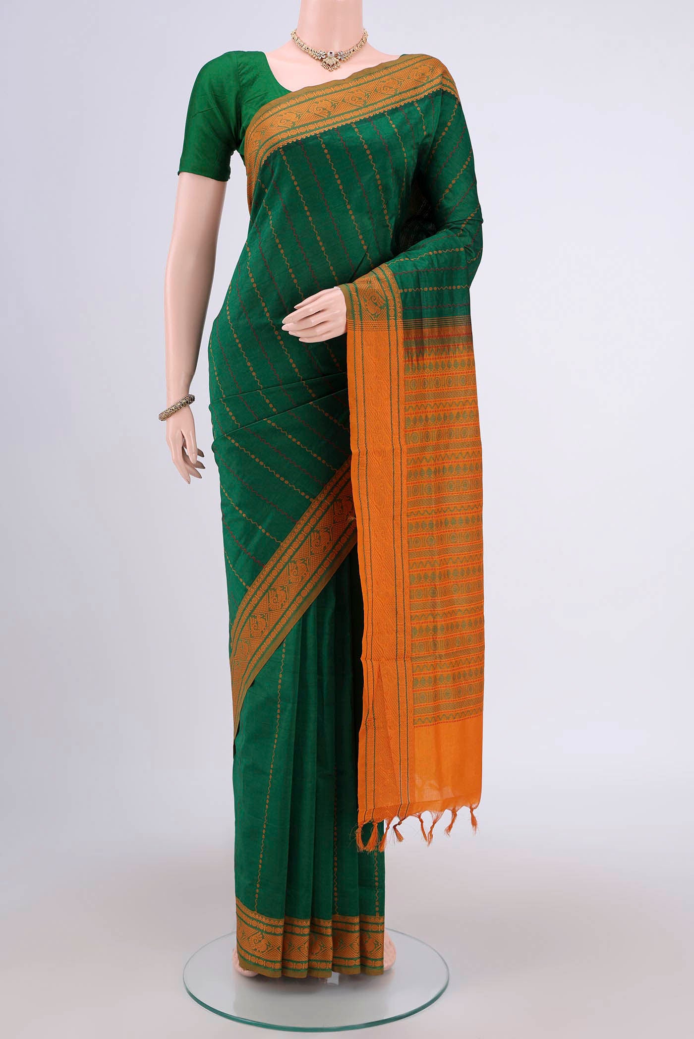Green Blended Silk Cotton Saree with Stripes on the body and Thread Border.  displayed on a mannequin