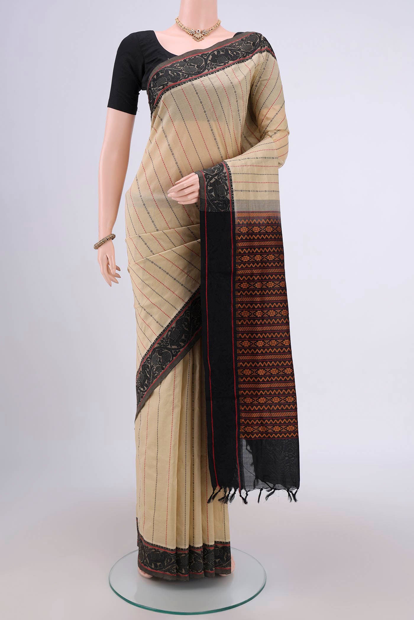 Beige Blended Silk Cotton Saree with Stripes on the body and Thread Border.  displayed on a mannequin