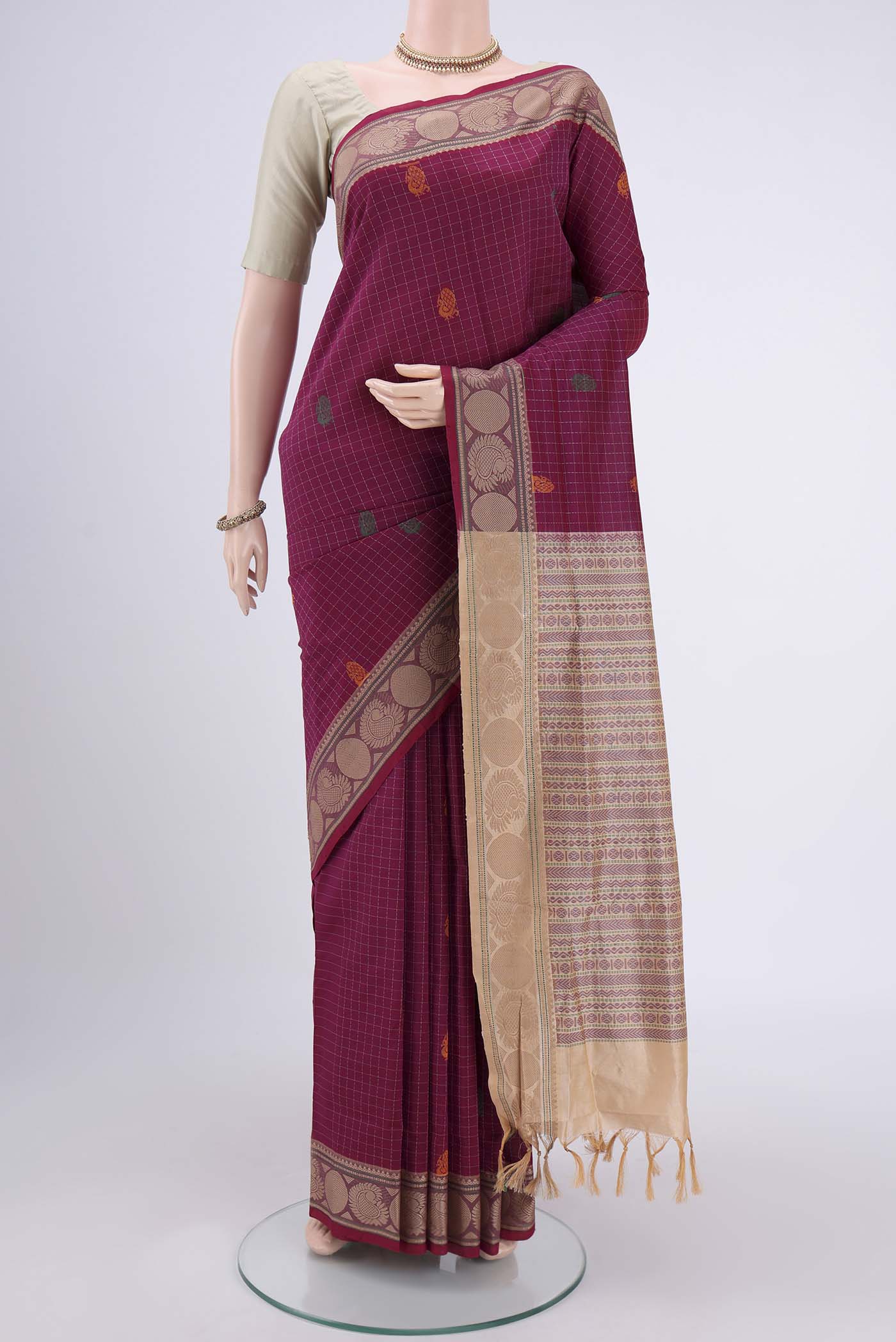 Magenta Blended Poly Cotton Saree with Checked design on the body and Thread Border.  displayed on a mannequin