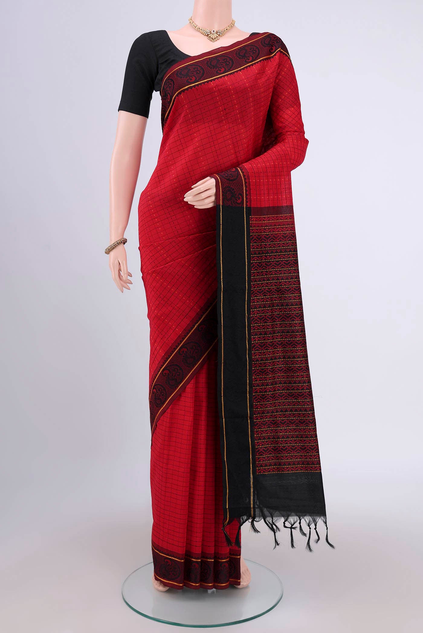 Red Blended Silk Cotton Saree with Checked design on the body and Thread Border.  displayed on a mannequin