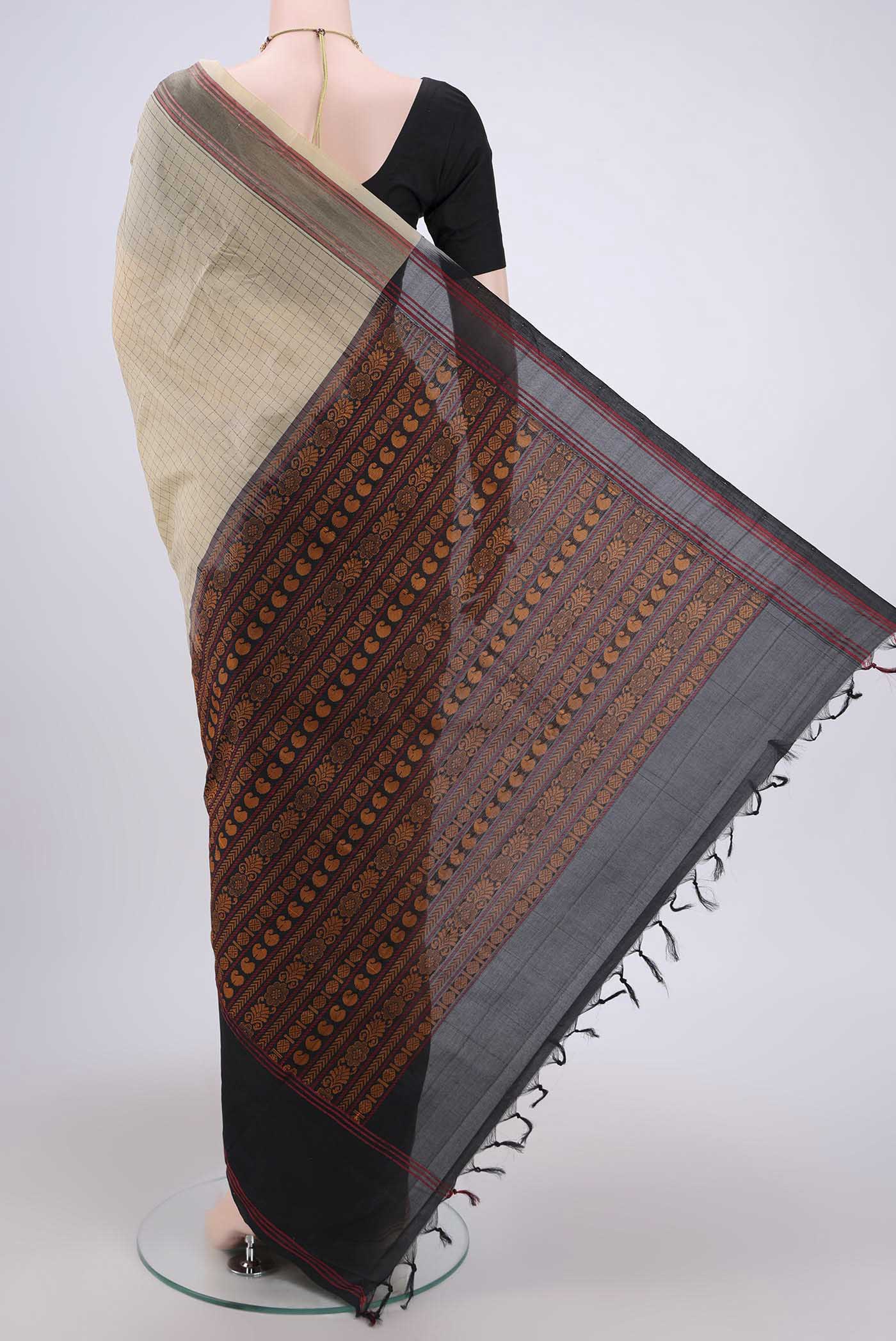 Flat view of Beige Blended Silk Cotton Saree with Checked design on the body and Thread Border. 