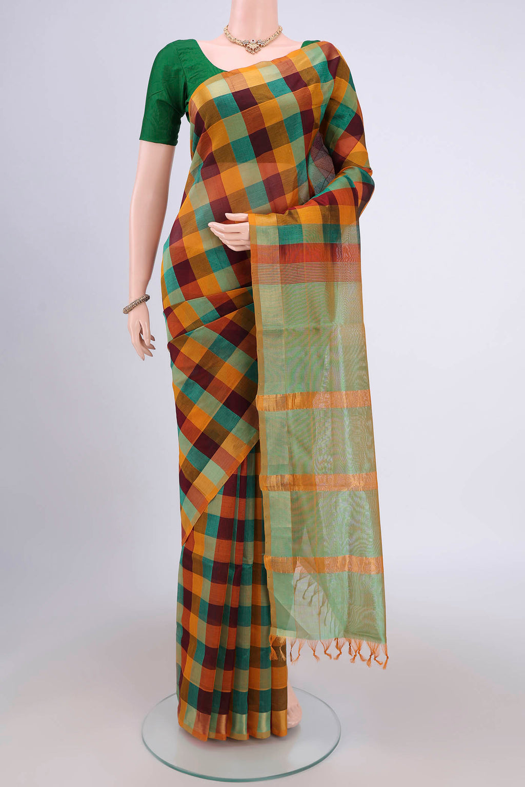 Multi Color Blended Poly Cotton Saree with Checked design on the body and Zari Border.  displayed on a mannequin