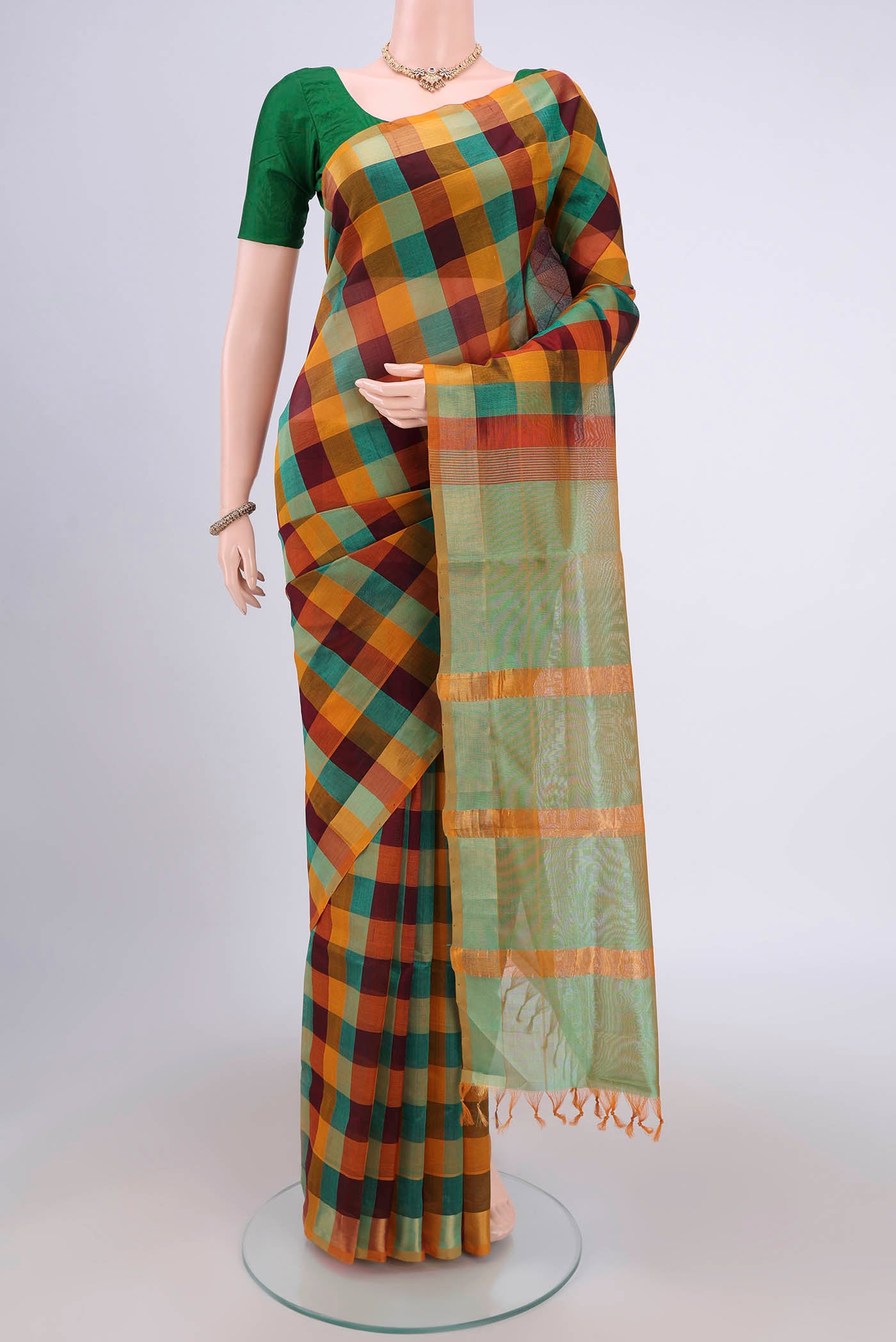 Multi Color Blended Poly Cotton Saree with Checked design on the body and Zari Border.  displayed on a mannequin