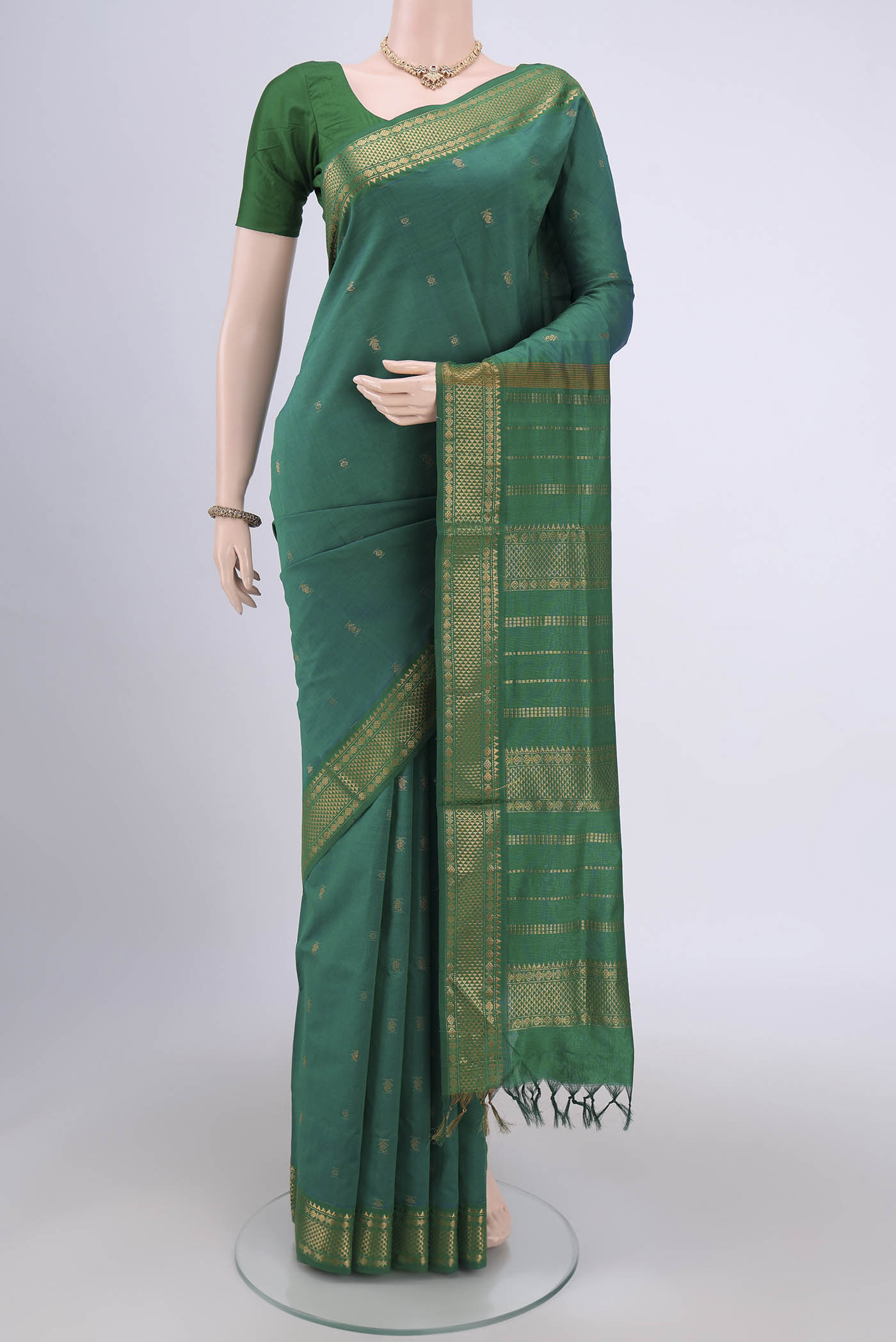 Sea Green Blended Poly Cotton Saree with Zari Butta on the body and Zari Border.  displayed on a mannequin