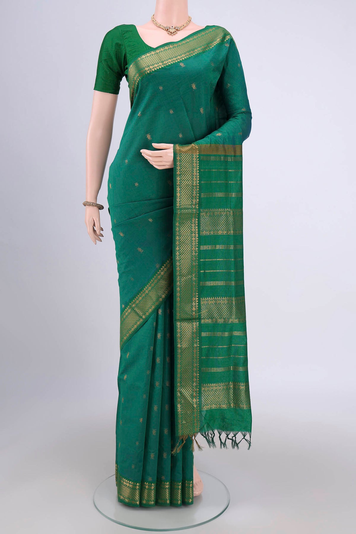 Sea Green Blended Poly Cotton Saree with Zari Butta on the body and Zari Border.  displayed on a mannequin