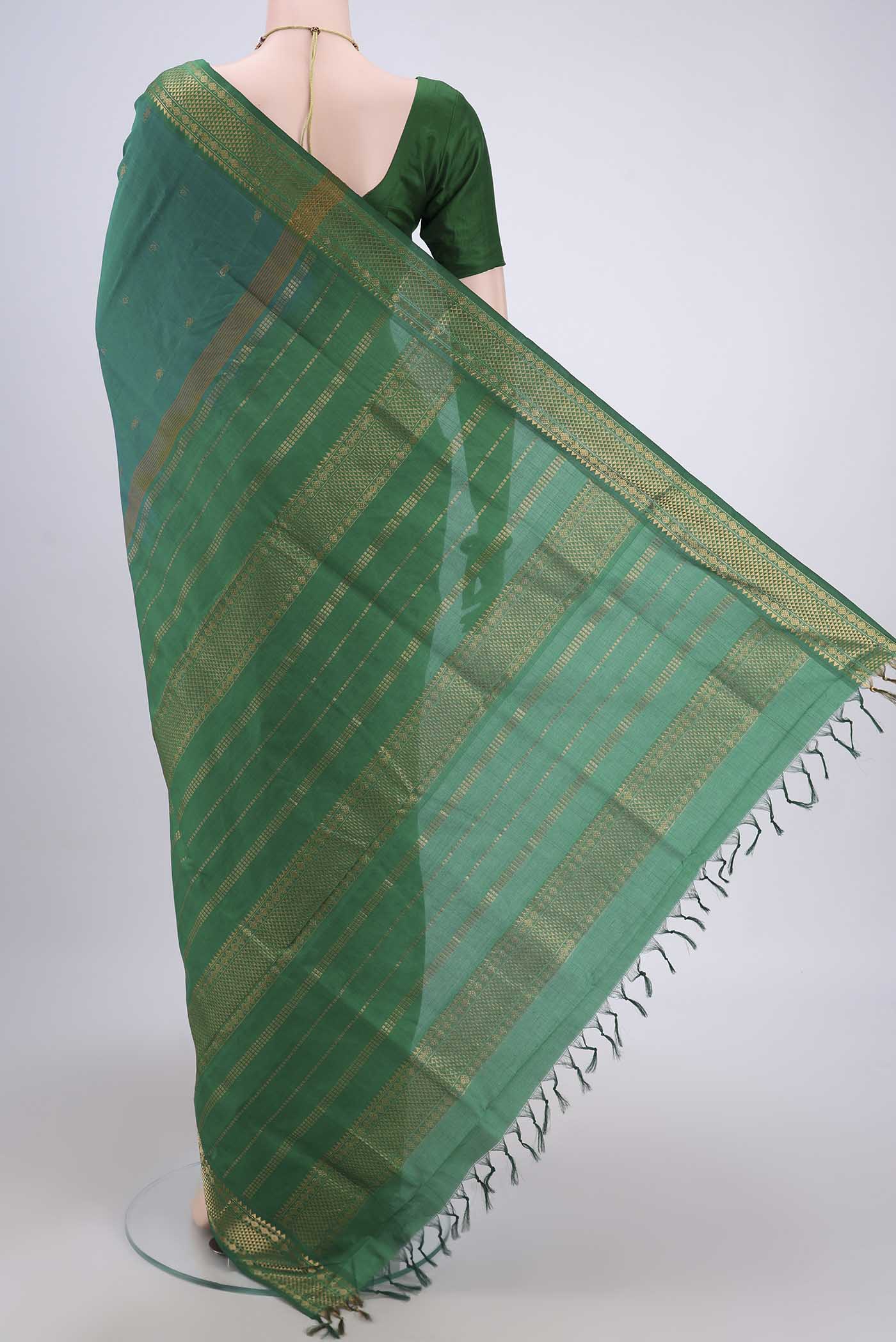 Flat view of Sea Green Blended Poly Cotton Saree with Zari Butta on the body and Zari Border. 