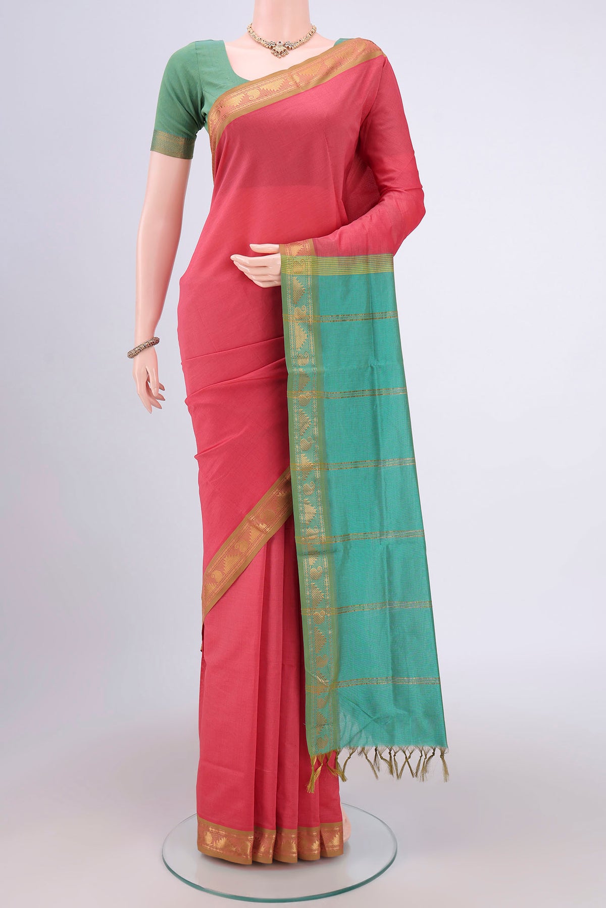 Peach Blended Poly Cotton Saree with Plain Body and Zari Border.  displayed on a mannequin