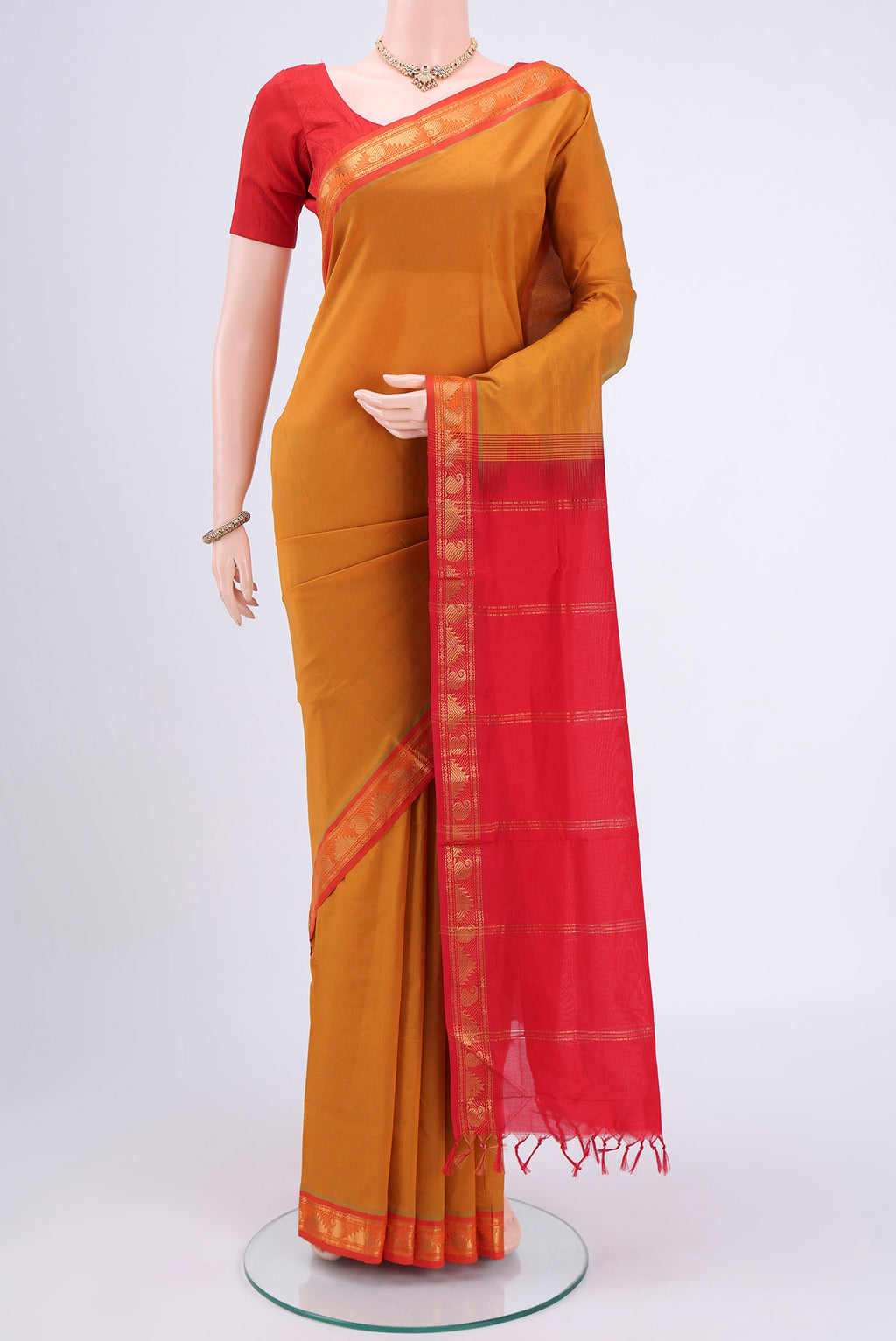 Mustard Blended Poly Cotton Saree with Plain Body and Zari Border.  displayed on a mannequin