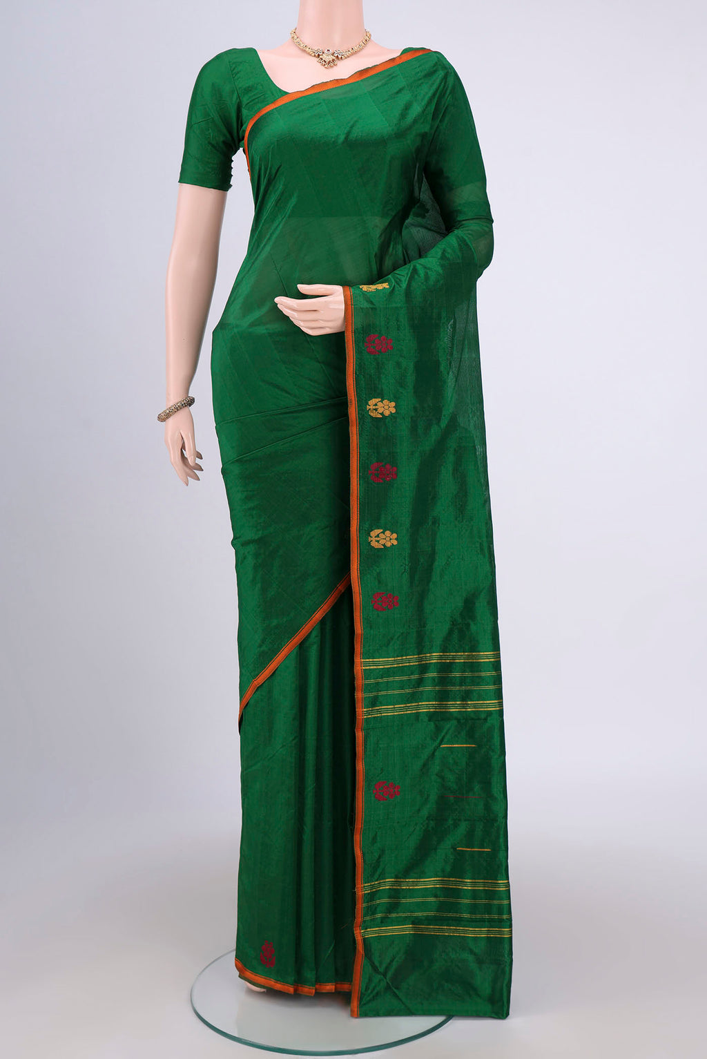 Bottle Green Kanchipuram Silk Saree with Plain Body and Thread Border.  displayed on a mannequin