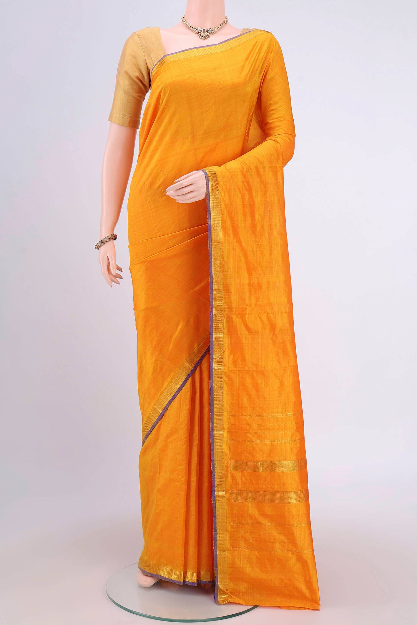 Yellow Kanchipuram Silk Saree with Plain Body and Zari Border.  displayed on a mannequin