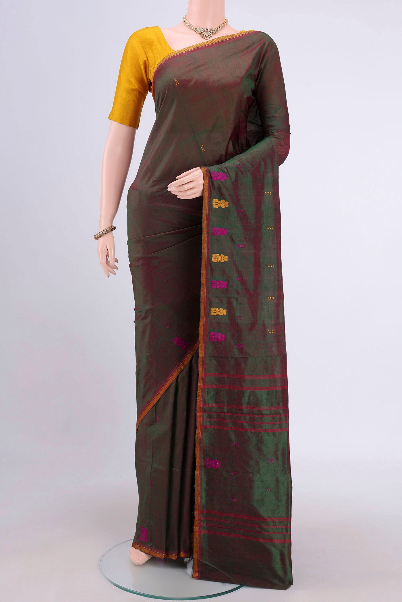 Green Kanchipuram Silk Saree with Plain Body and Thread Border.  displayed on a mannequin
