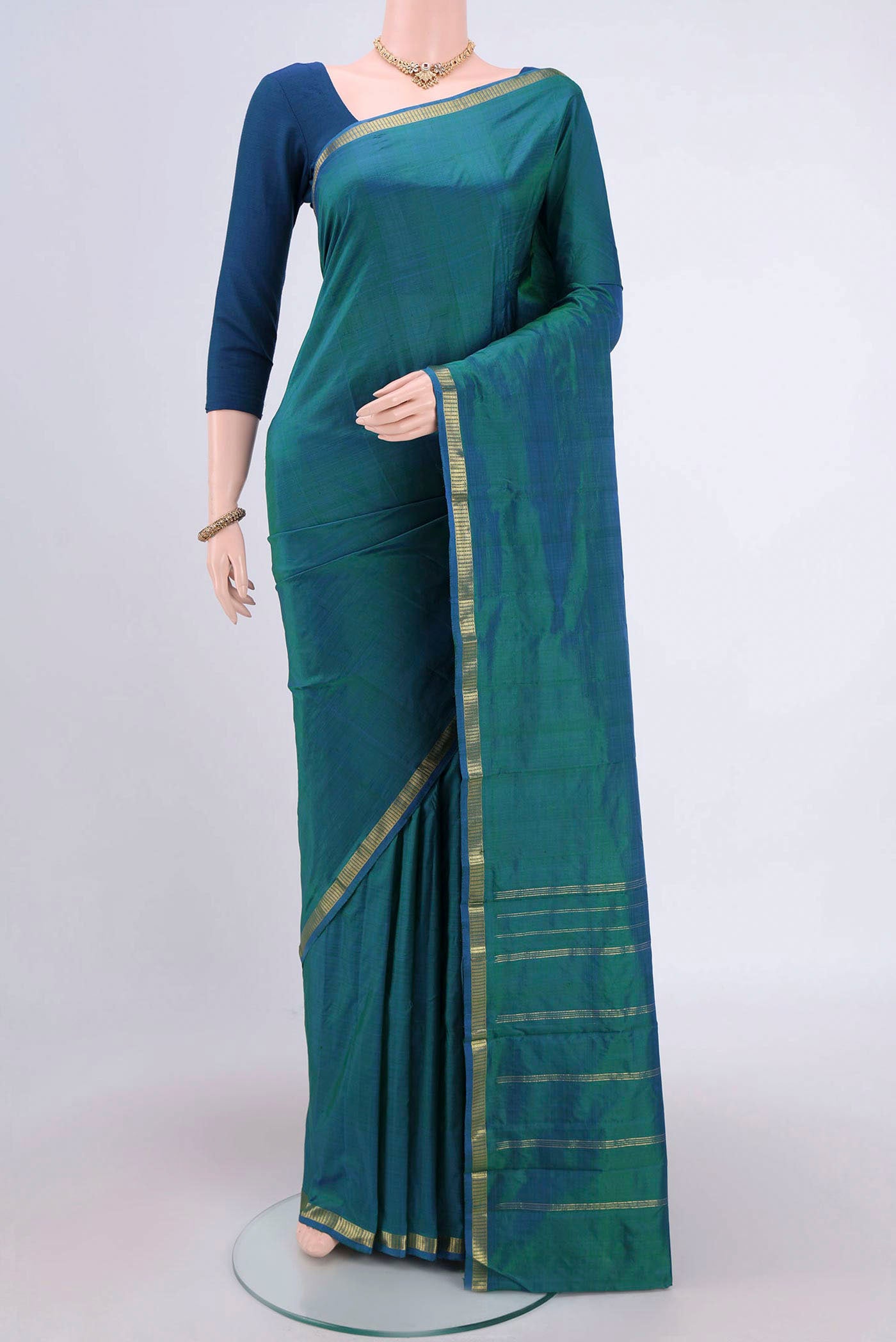 Sea Green Kanchipuram Silk Saree with Plain Body and Zari Border.  displayed on a mannequin