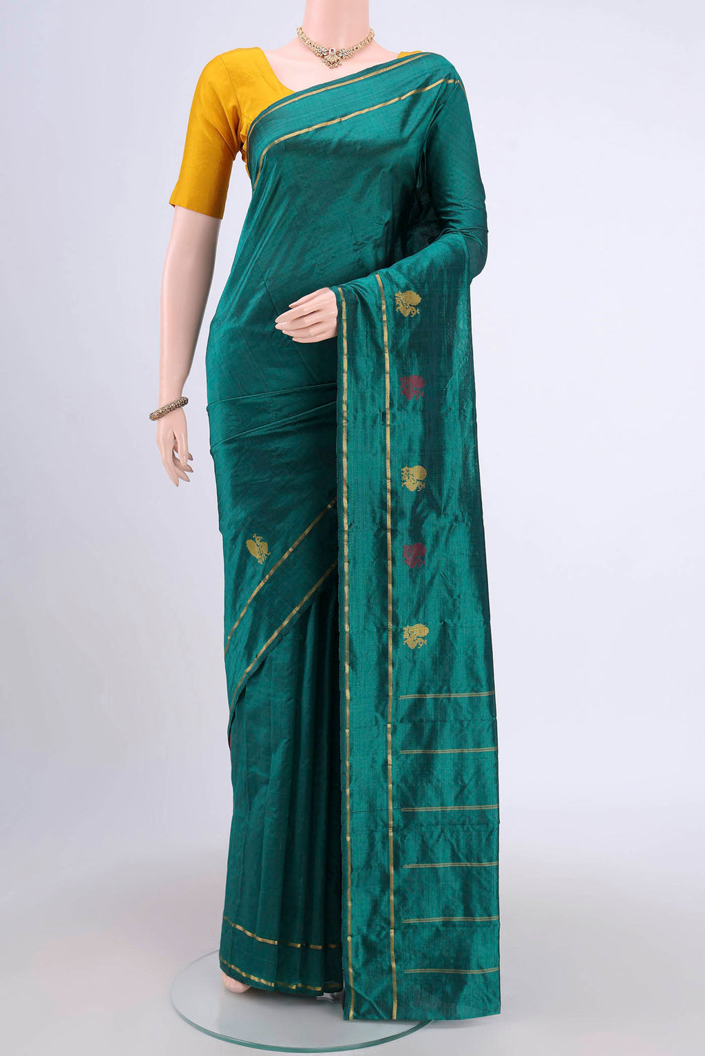 Green Kanchipuram Saree with Plain Body and Zari And Thread Border.  displayed on a mannequin