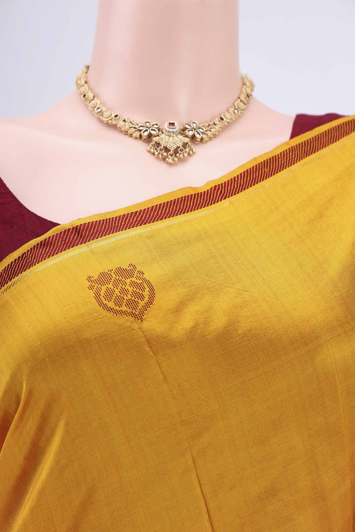 Border image of Mustard Kanchipuram Saree with Plain Body and Zari And Thread Border. 