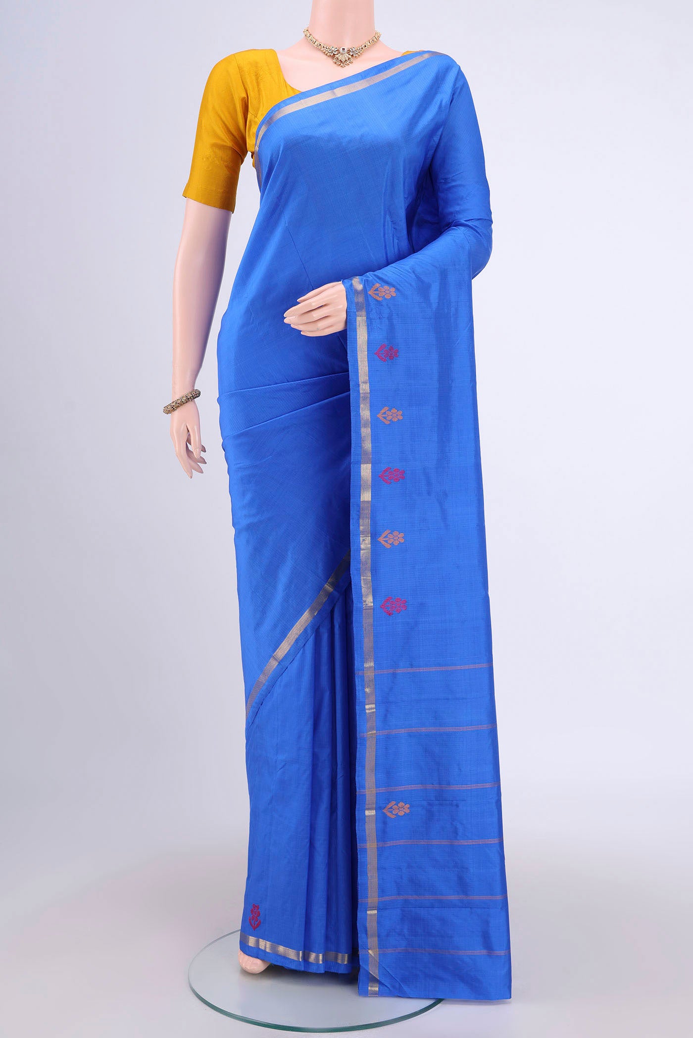Blue Kanchipuram Saree with Plain Body and Zari And Thread Border.  displayed on a mannequin