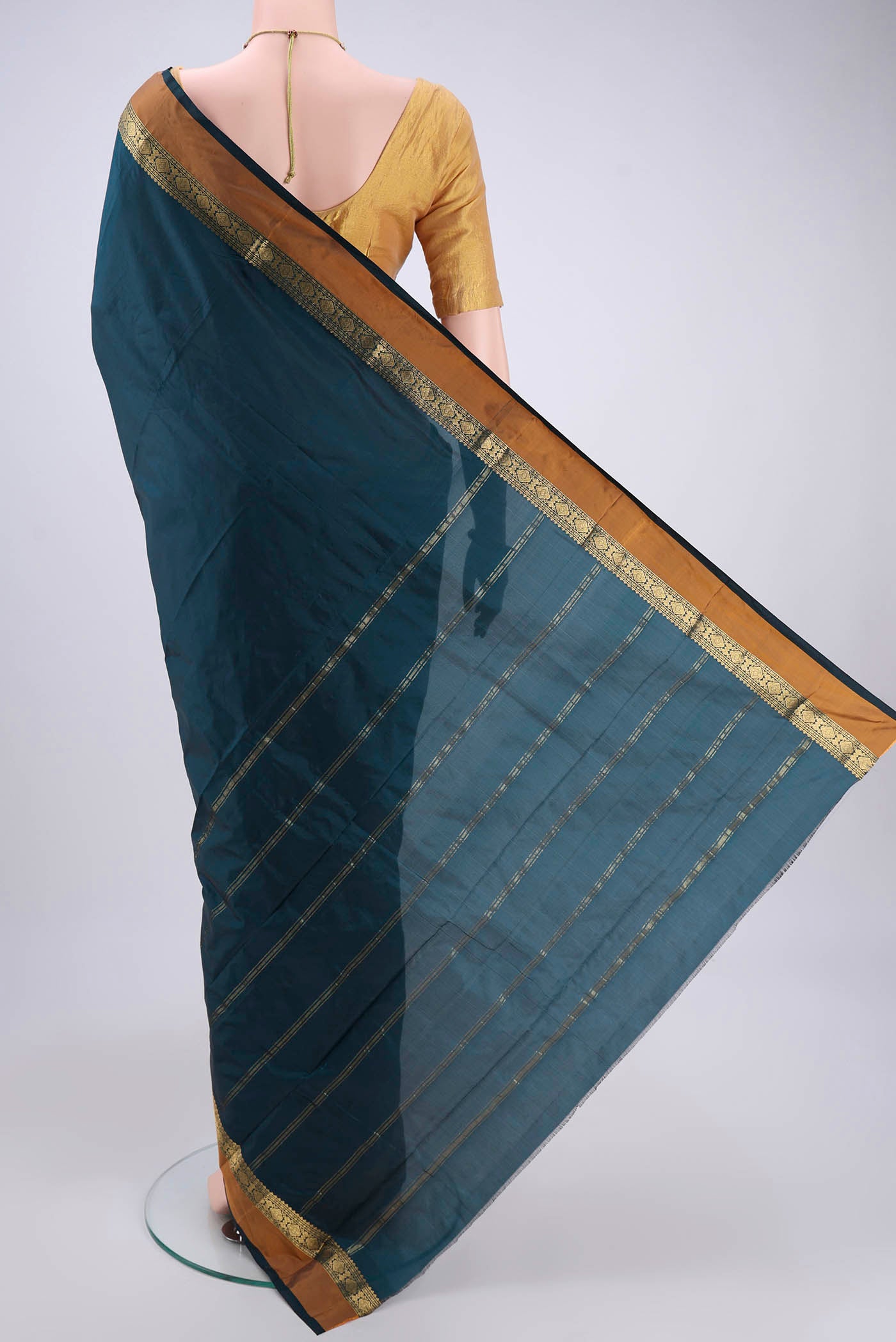 Flat view of Bottle Green Blended Bangalore Silk Saree with Zari Butta on the body and Zari Border. 