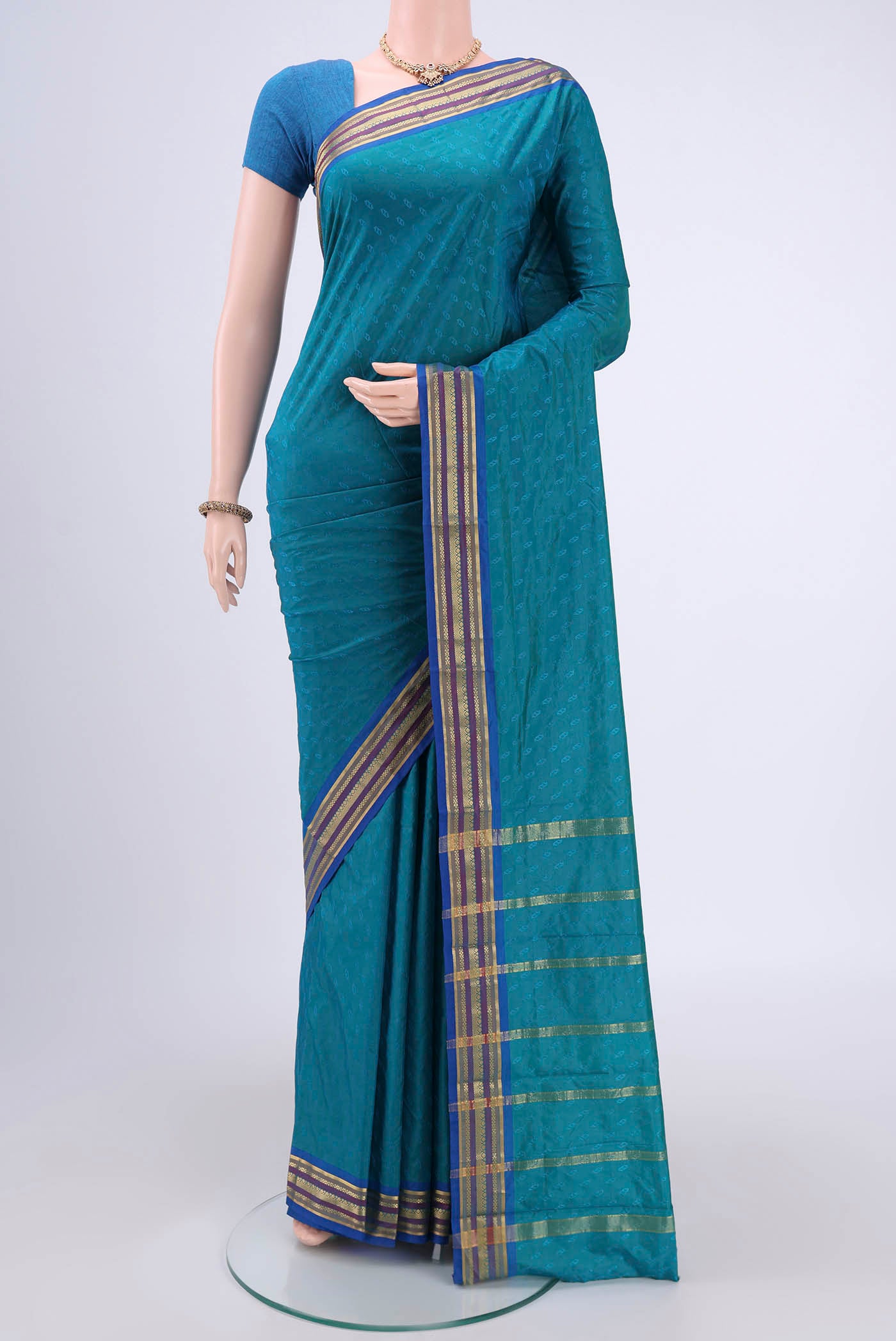 Turquoise Blended Bangalore Silk Saree with Zari Butta on the body and Zari Border.  displayed on a mannequin