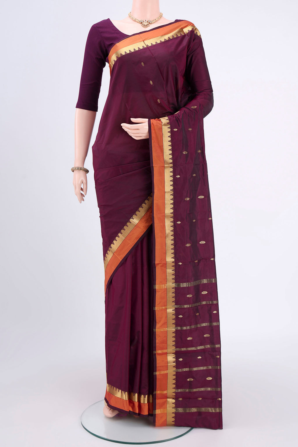 Magenta Blended Bangalore Silk Saree with Zari Butta on the body and Zari Border.  displayed on a mannequin