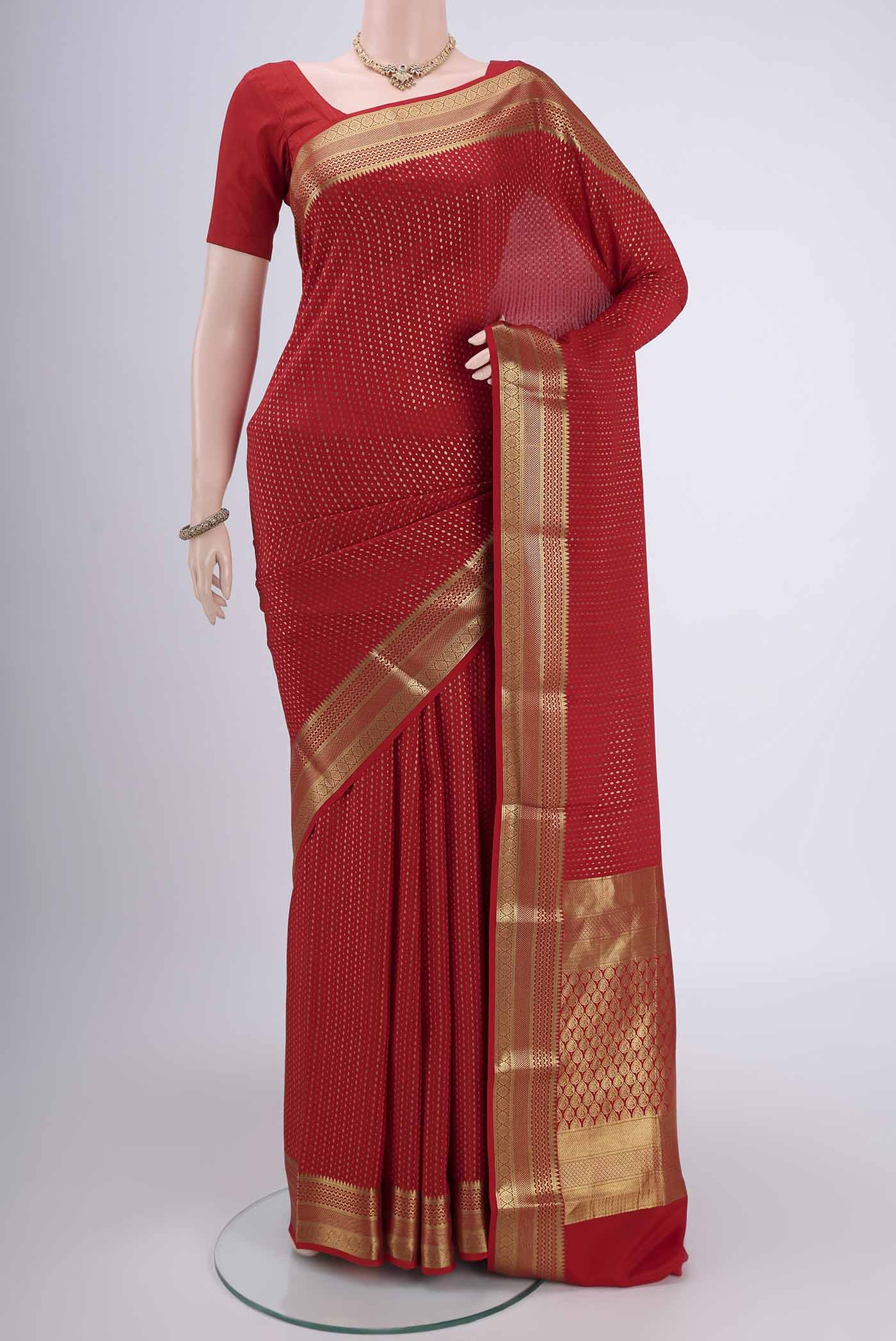 Red Mysore Crepe Saree with Zari Butta on the body and Zari Border.  displayed on a mannequin