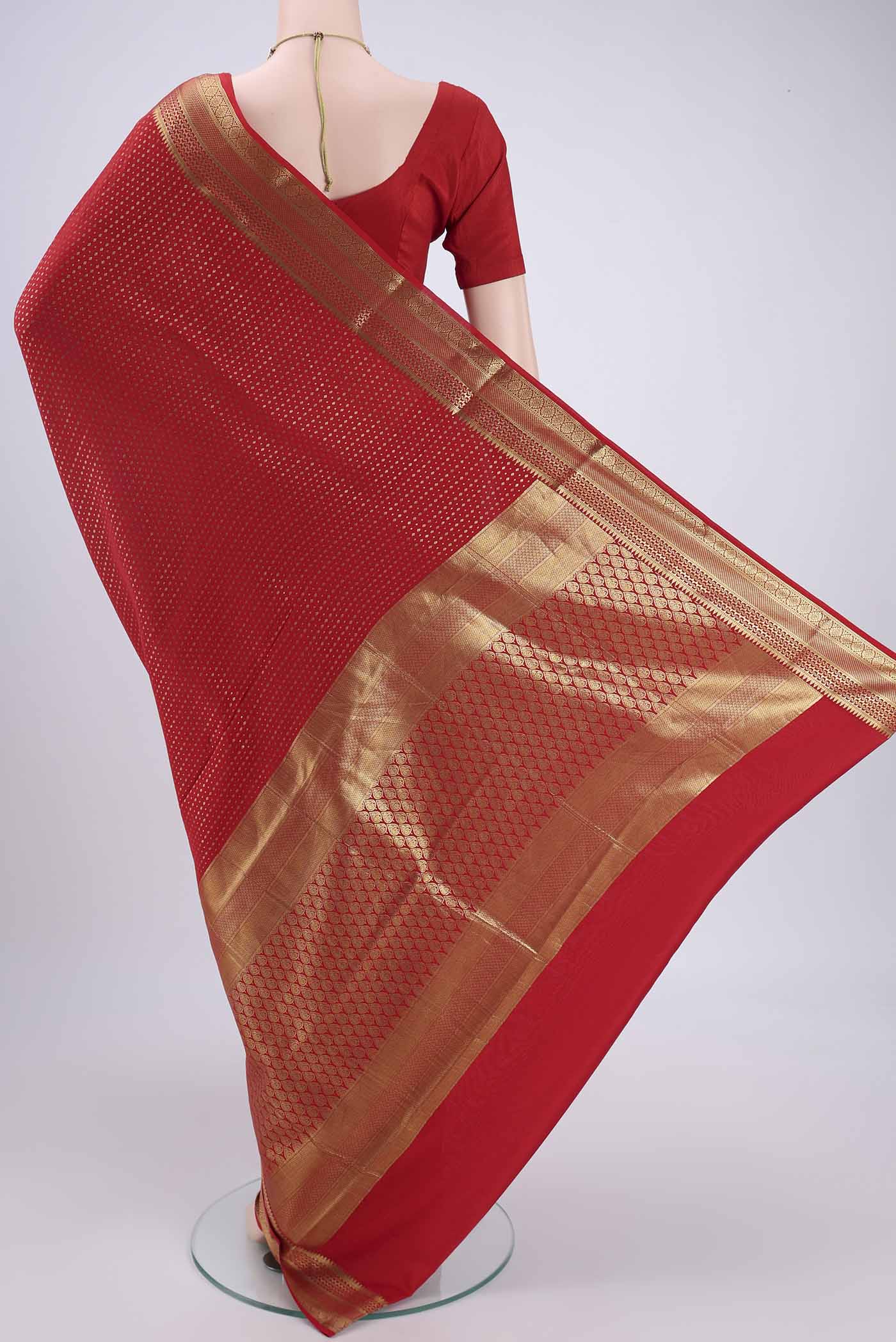 Flat view of Red Mysore Crepe Saree with Zari Butta on the body and Zari Border. 