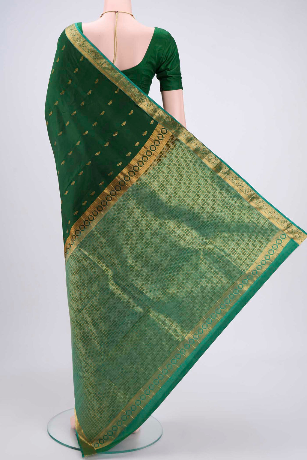 Flat view of Bottle Green Kanjivaram Silk Saree with Zari Butta on the body and Zari Border. 