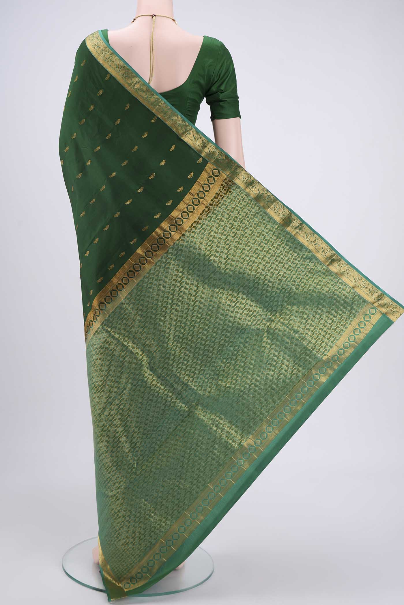 Flat view of Bottle Green Kanjivaram Silk Saree with Zari Butta on the body and Zari Border. 