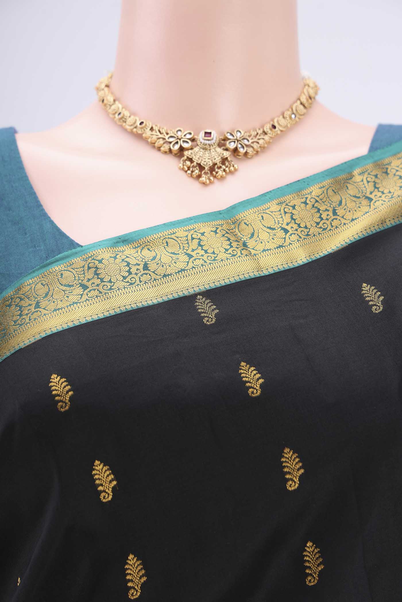 Border image of Black Kanjivaram Silk Saree with Zari Butta on the body and Zari Border. 