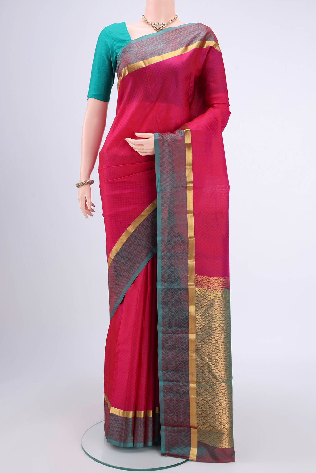 Pink Kanjivaram Silk Saree with Zari Butta on the body and Zari Border.  displayed on a mannequin