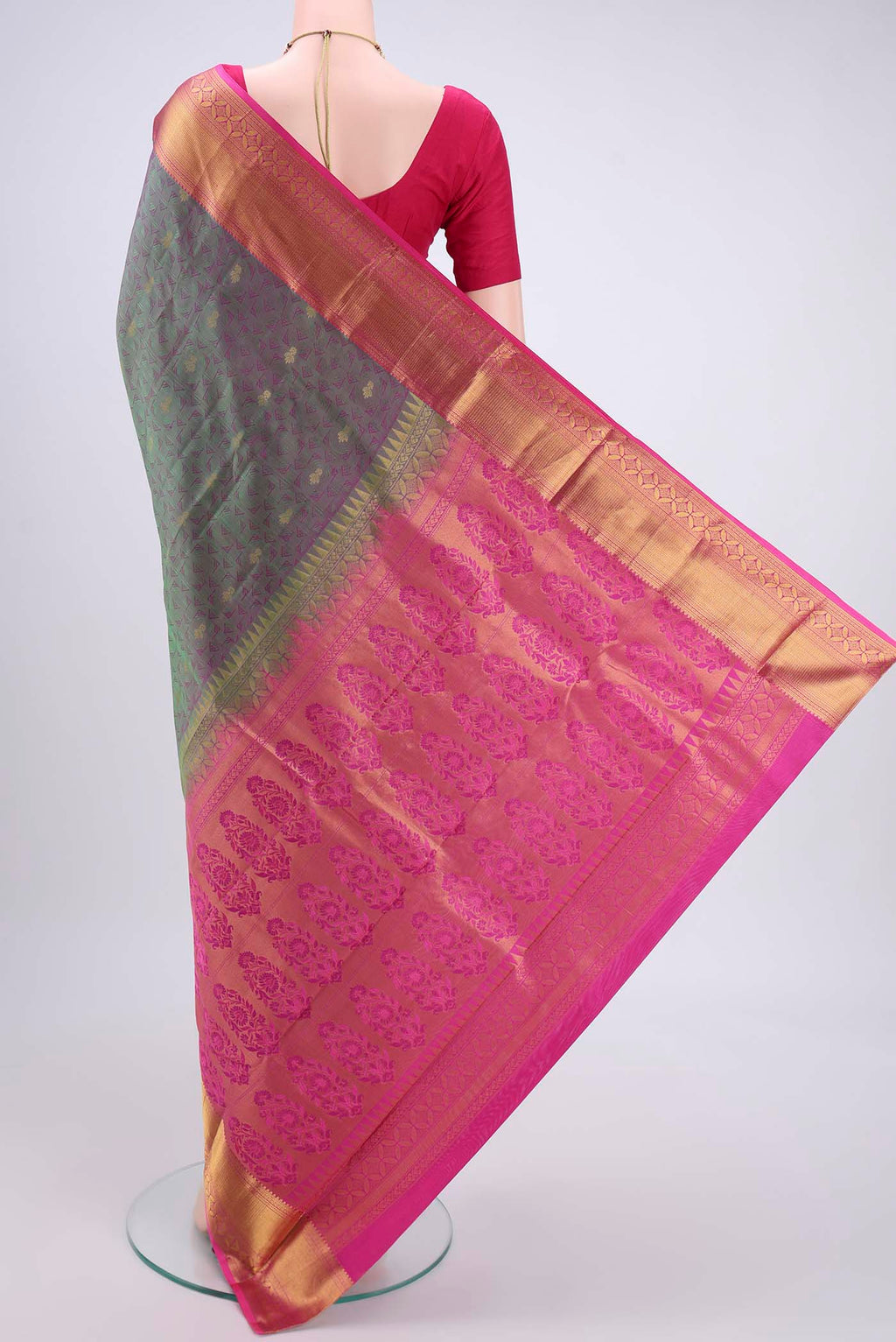 Flat view of Bottle Green Kanchipuram Silk Saree with Zari Butta on the body and Zari Border. 
