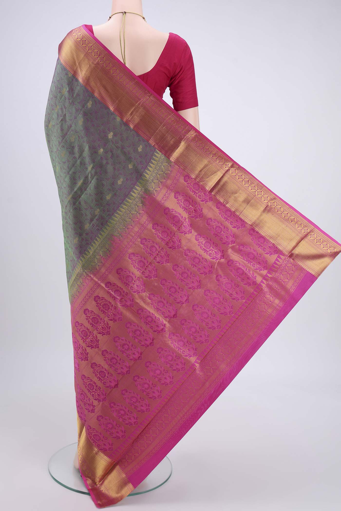 Flat view of Bottle Green Kanchipuram Silk Saree with Zari Butta on the body and Zari Border. 
