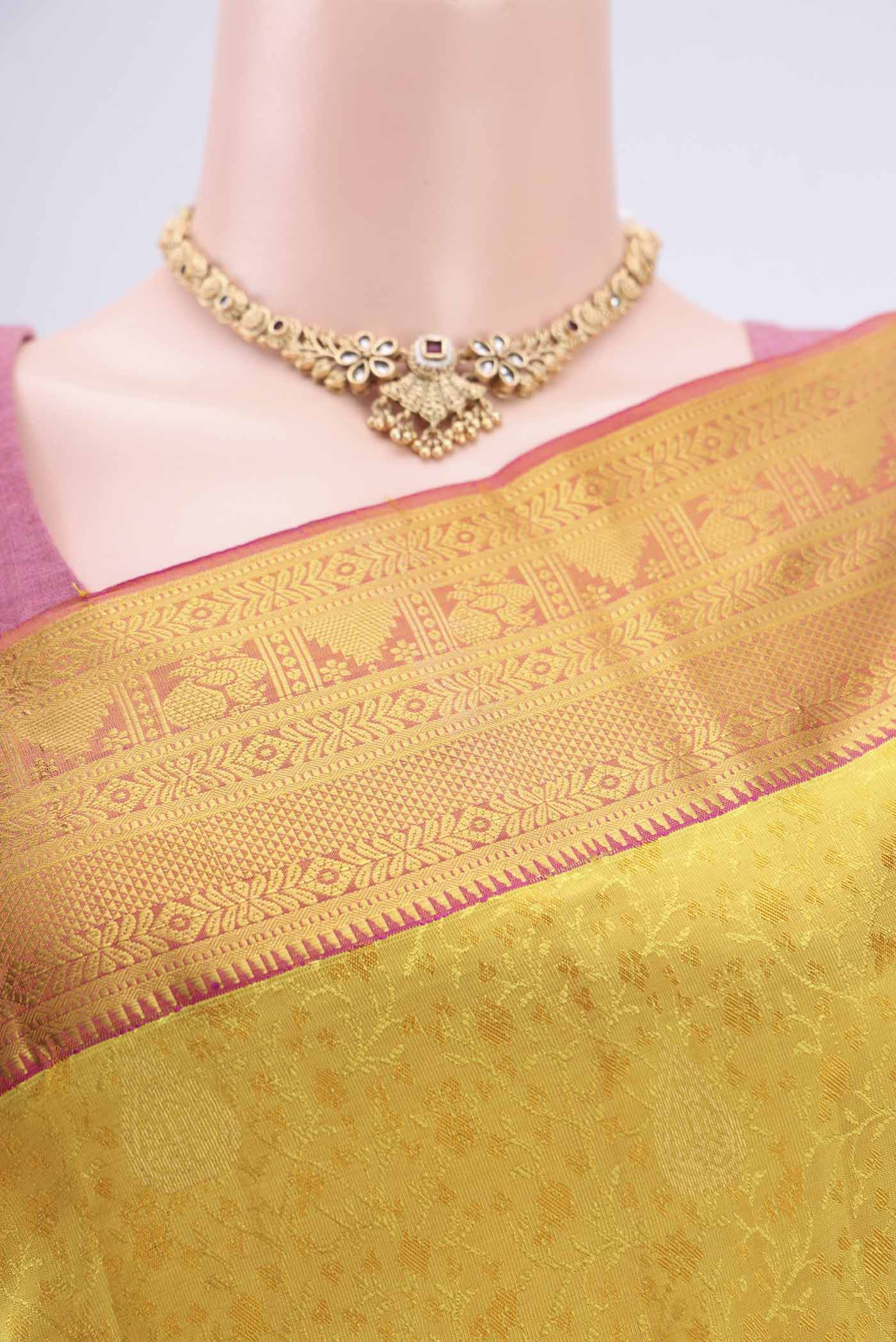 Border image of Yellow Kanchipuram Silk Saree with Zari Butta on the body and Zari Border. 
