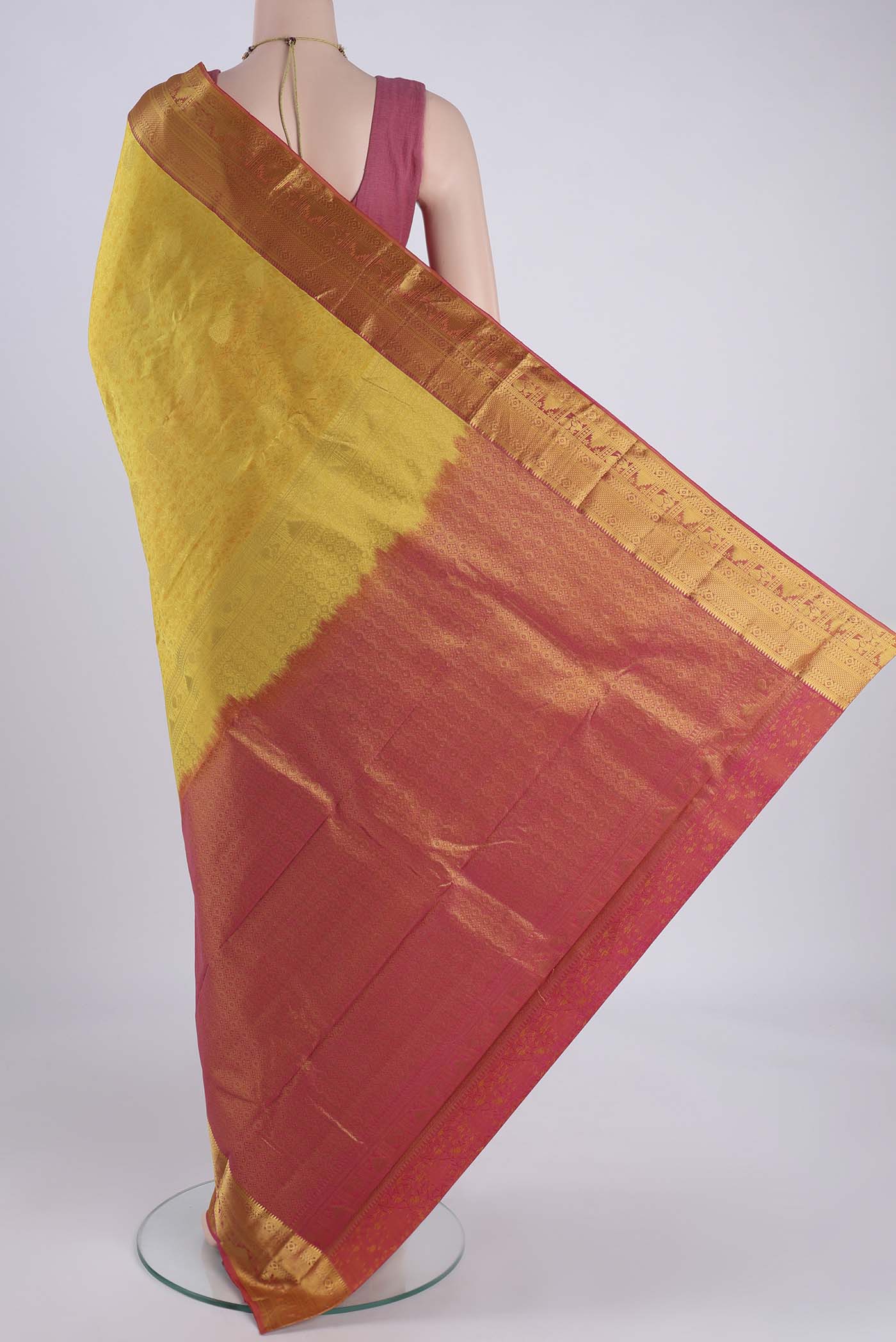 Flat view of Yellow Kanchipuram Silk Saree with Zari Butta on the body and Zari Border. 
