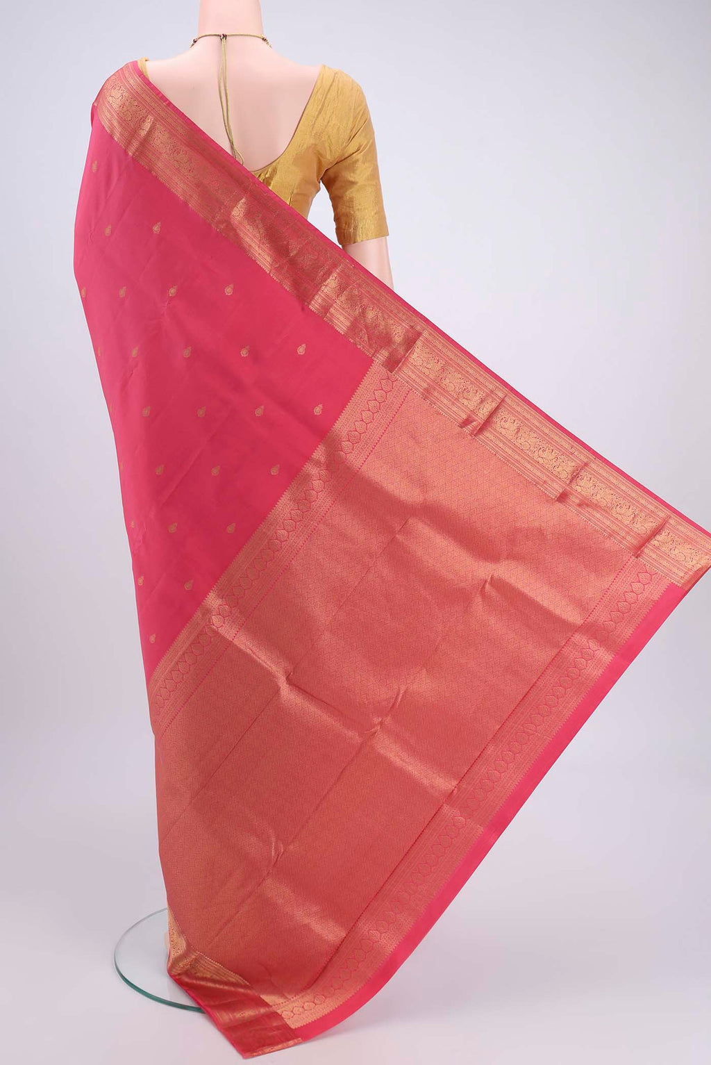 Flat view of Pink Kanchipuram Silk Saree with Zari Butta on the body and Zari Border. 