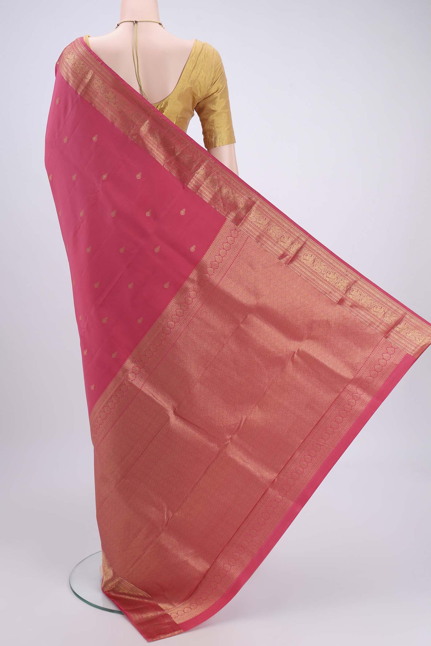 Flat view of Pink Kanchipuram Silk Saree with Zari Butta on the body and Zari Border. 