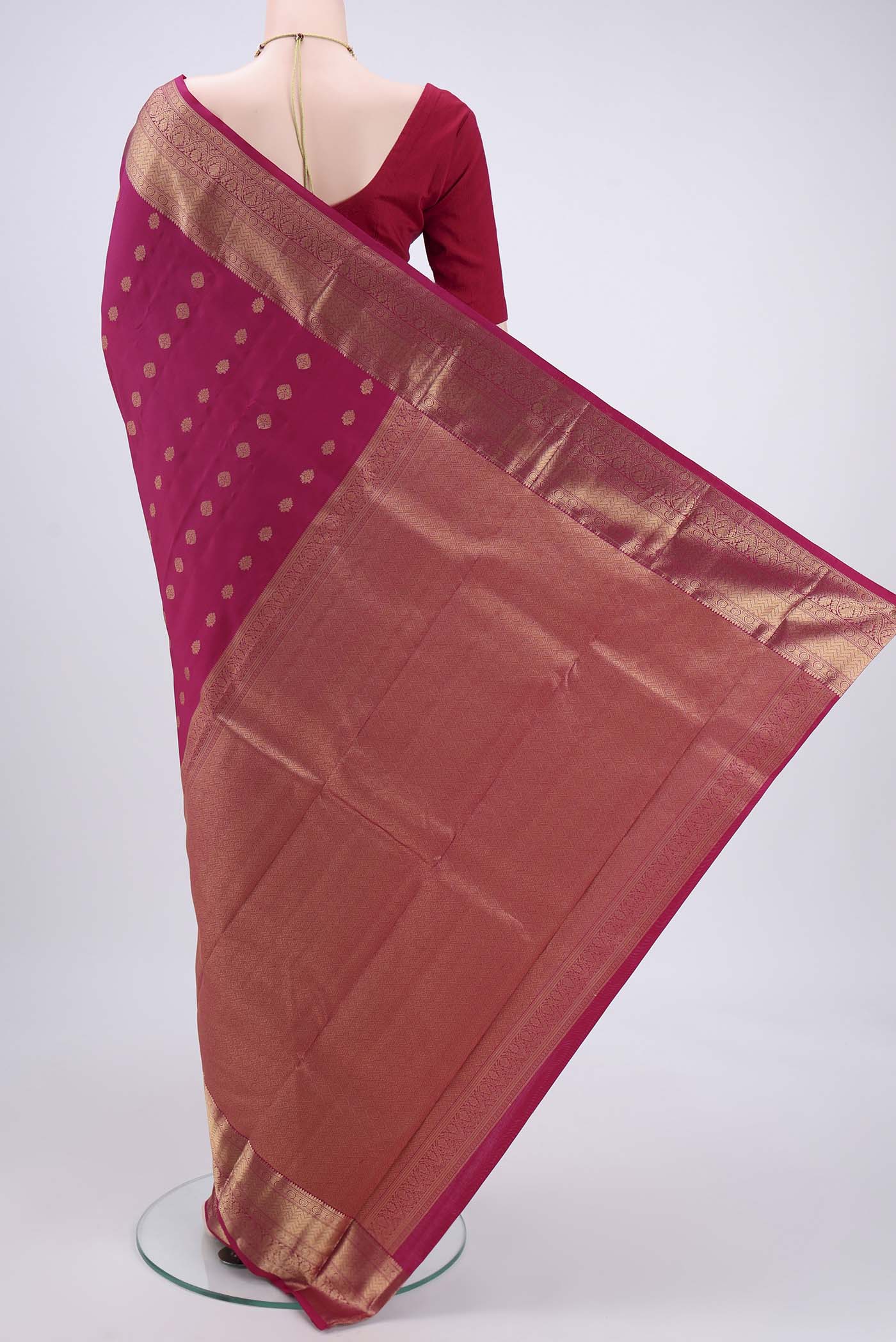 Flat view of Pink Kanchipuram Silk Saree with Zari Butta on the body and Zari Border. 