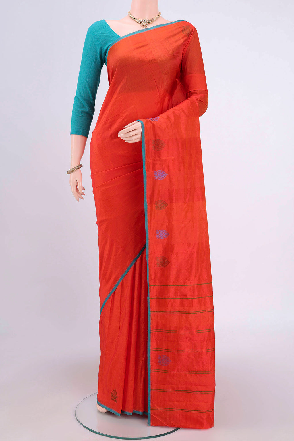 Brick Orange Kanchipuram Saree with Plain Body and Thread Border.  displayed on a mannequin