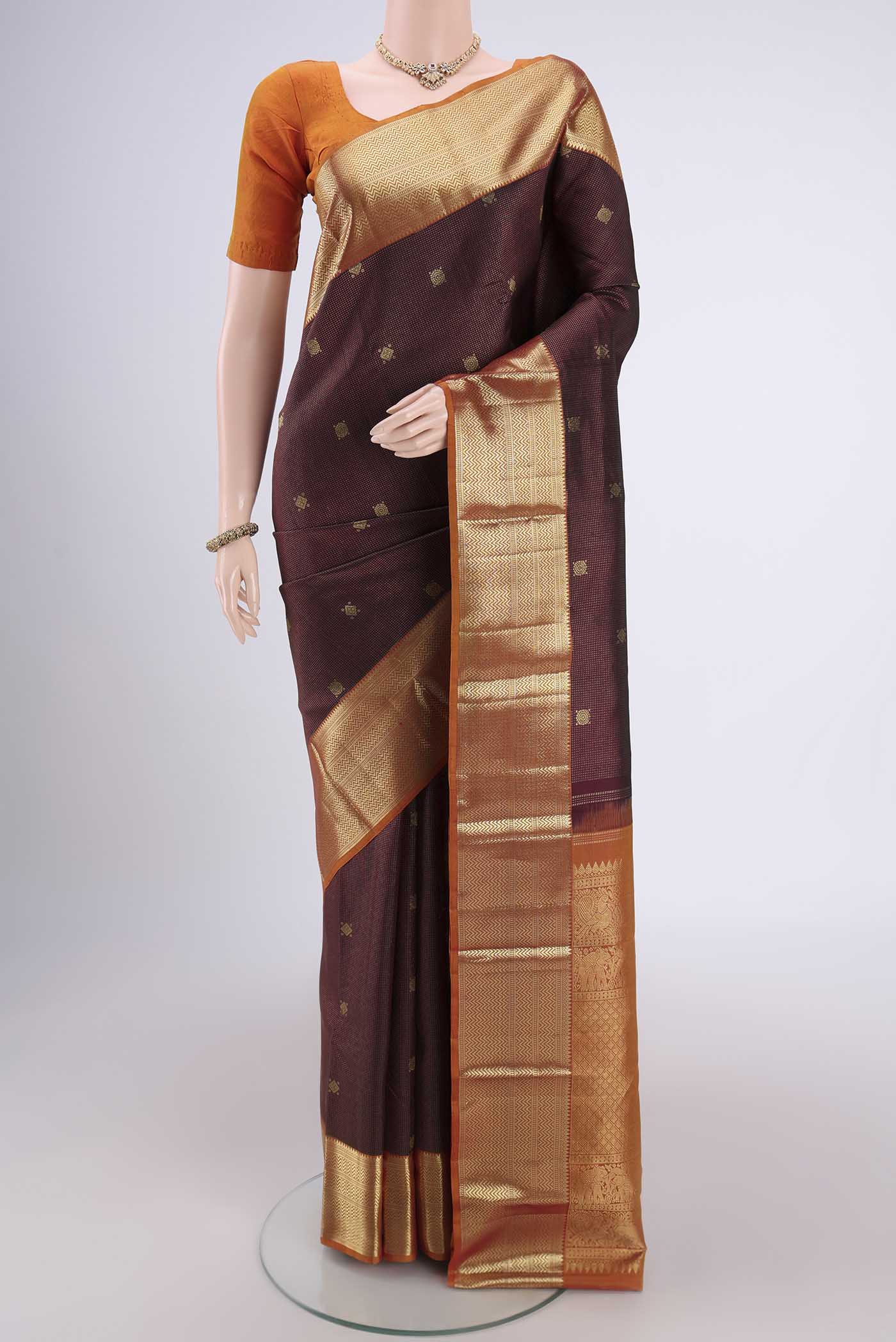 Maroon Kanjivaram Silk Saree with Zari Brocade on the body and Zari Border.  displayed on a mannequin
