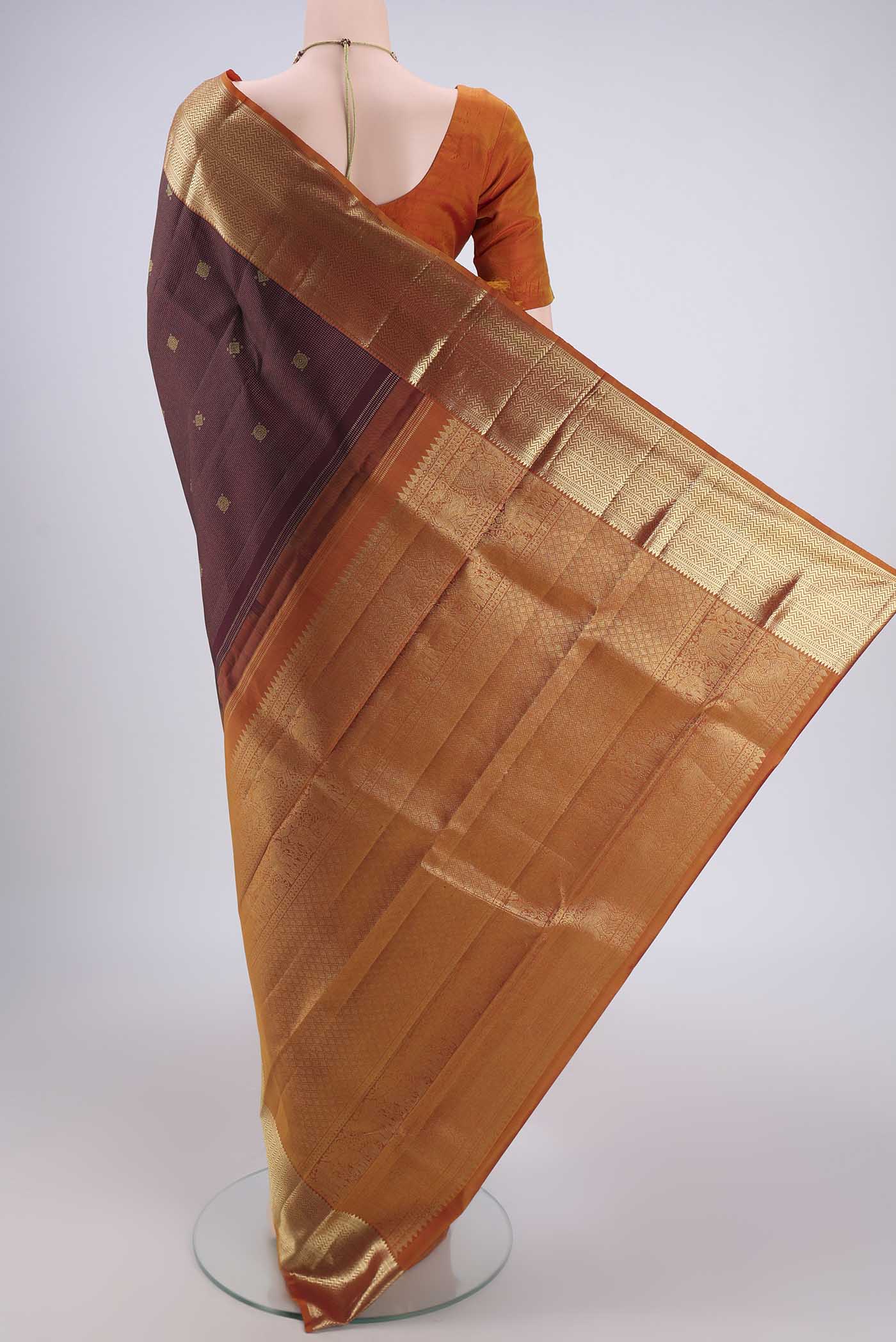 Flat view of Maroon Kanjivaram Silk Saree with Zari Brocade on the body and Zari Border. 