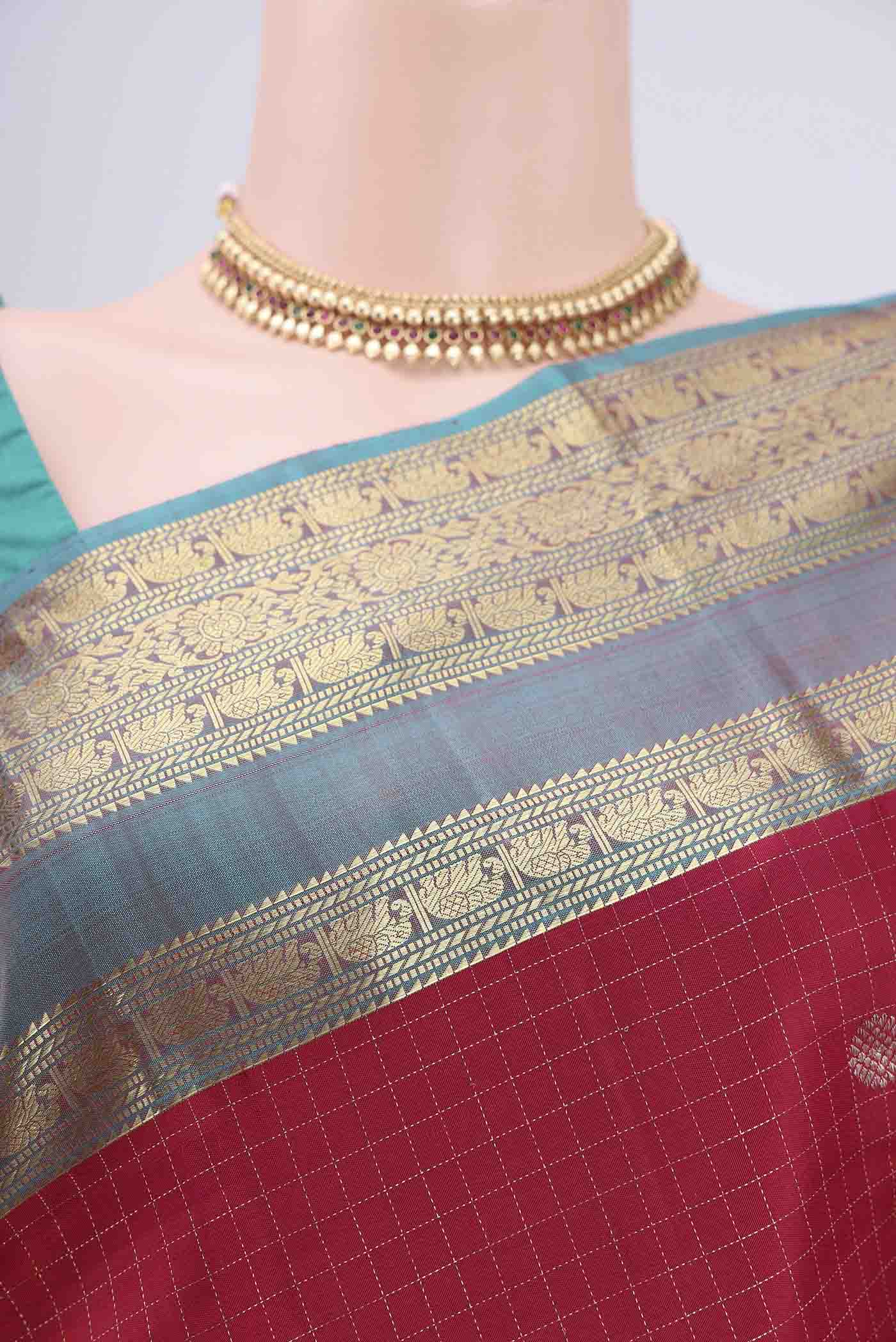 Border image of Maroon Kanjivaram Saree with Checked design on the body and Zari Border. 