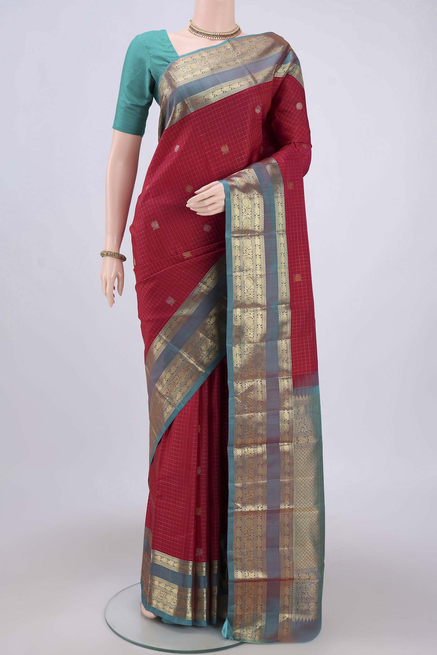 Maroon Kanjivaram Saree with Checked design on the body and Zari Border.  displayed on a mannequin