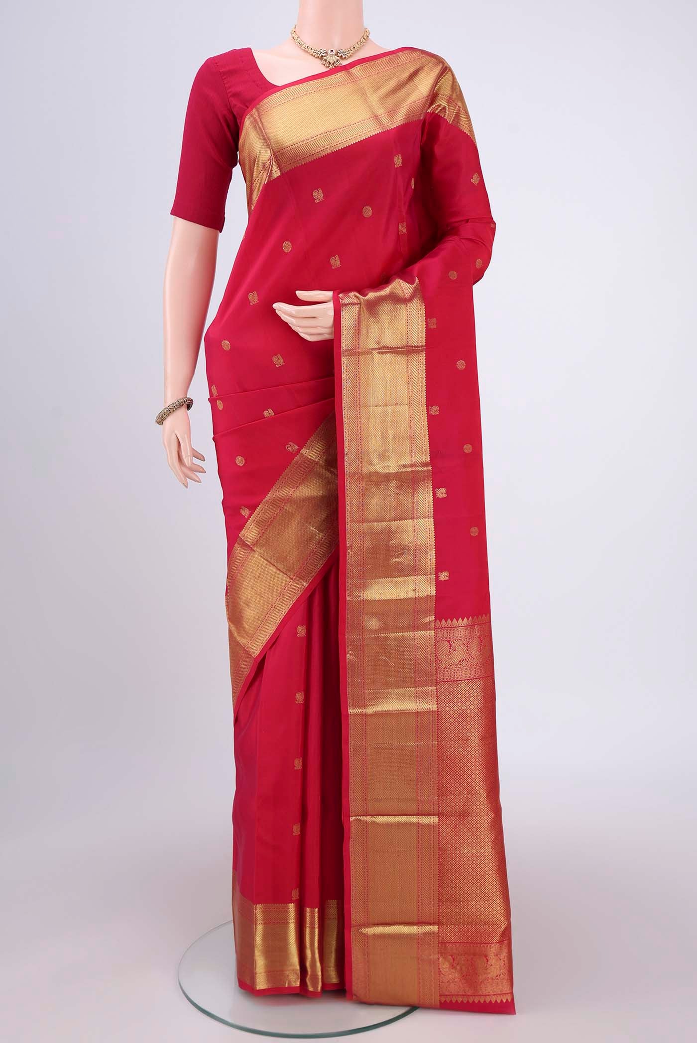 Dark Pink Kanchipuram Silk Saree with Zari Butta on the body and Zari Border.  displayed on a mannequin