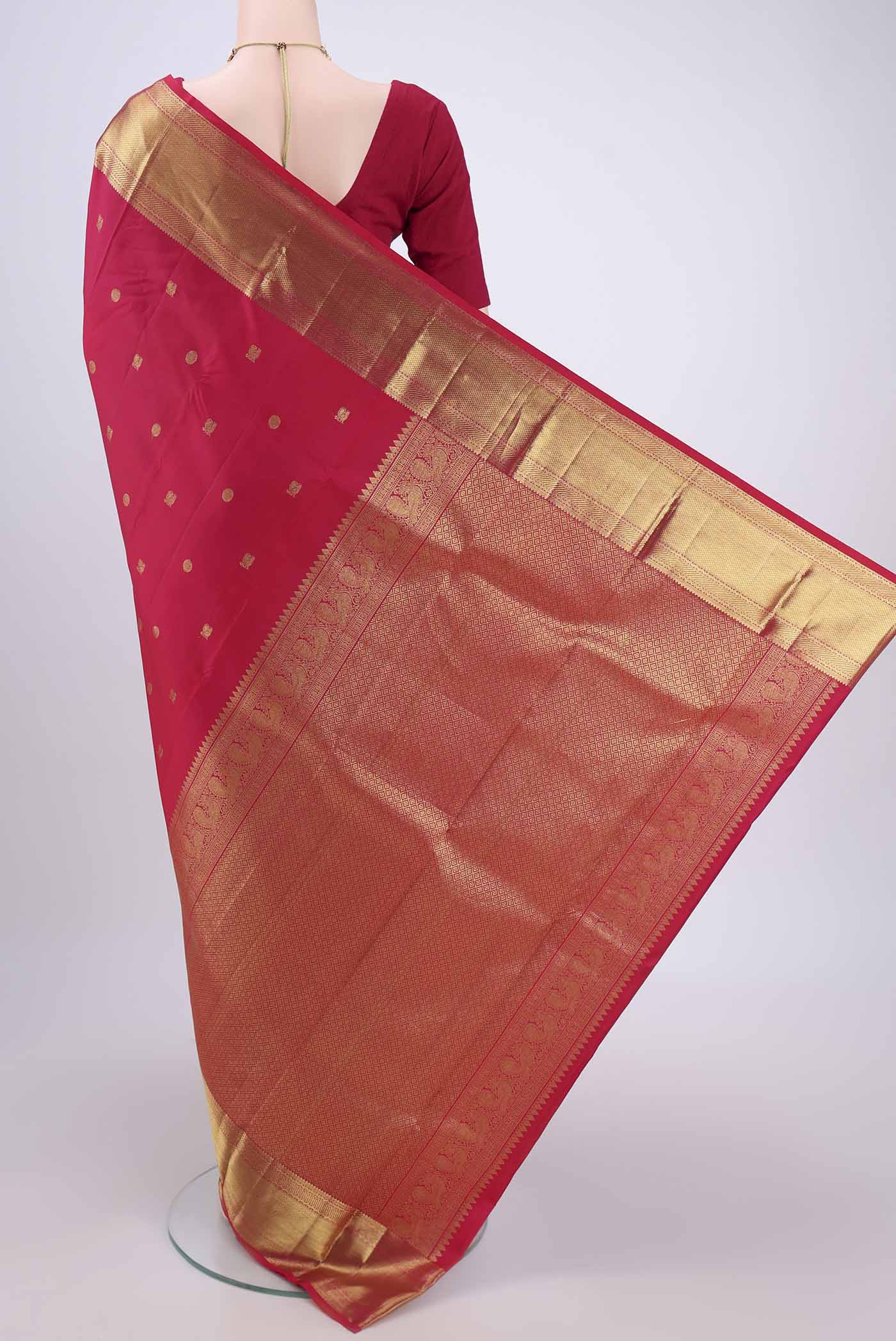 Flat view of Dark Pink Kanchipuram Silk Saree with Zari Butta on the body and Zari Border. 