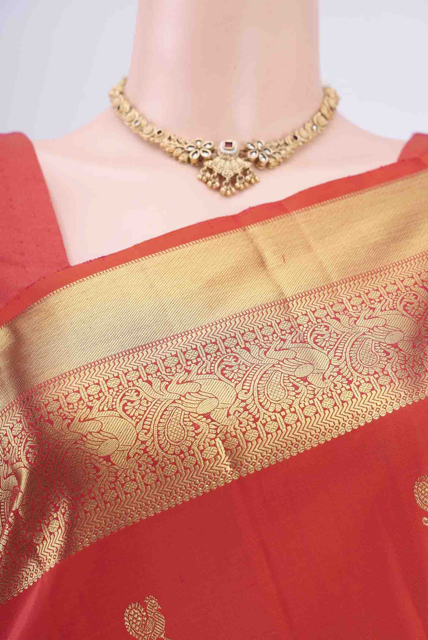 Border image of Orange Kanchipuram Silk Saree with Zari Butta on the body and Zari Border. 