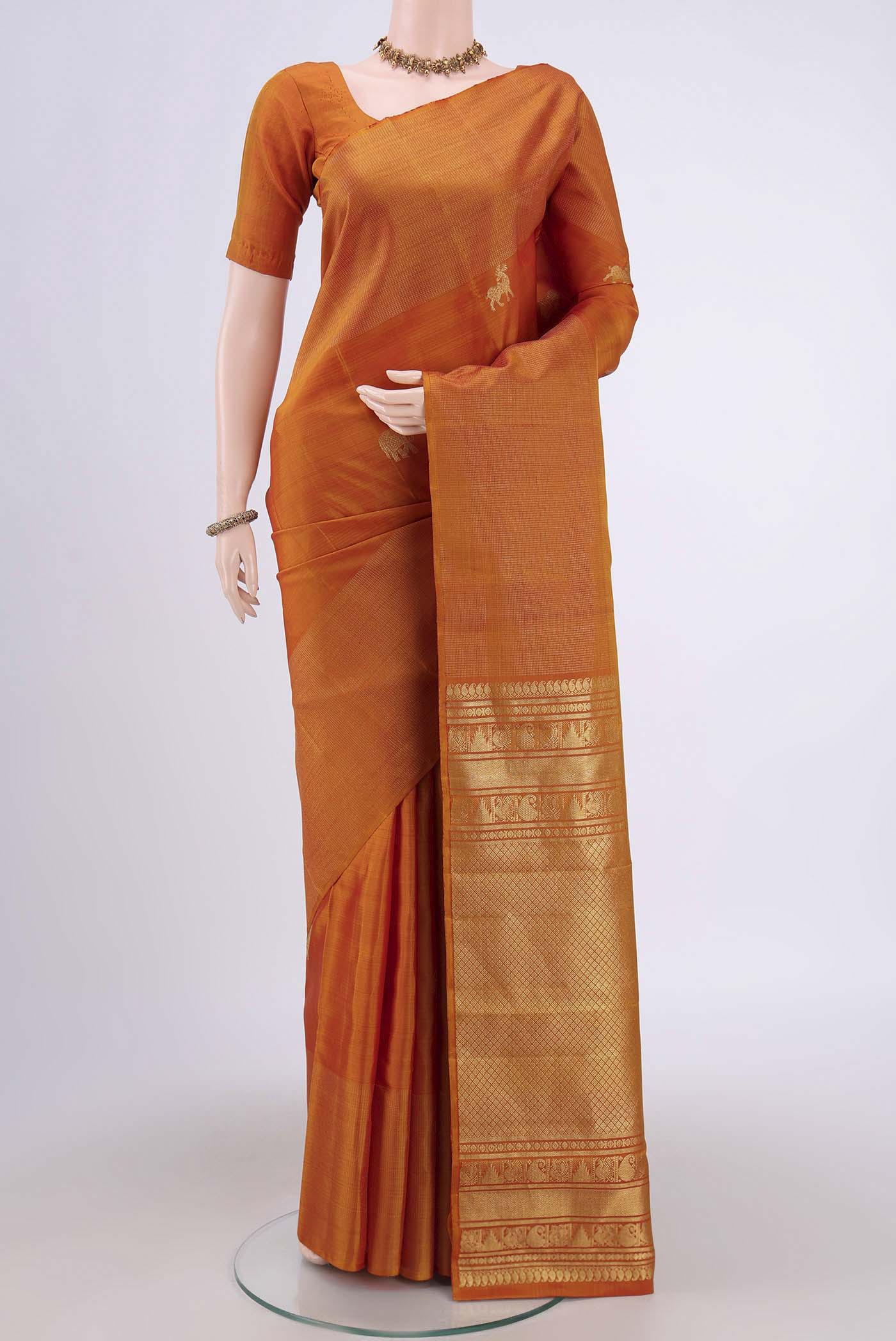 Mustard Dual Tone Kanjivaram Silk Saree with Zari Butta on the body and Zari Border.  displayed on a mannequin