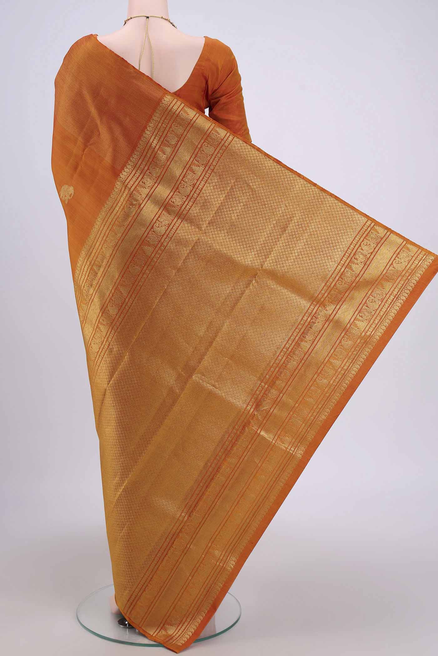 Flat view of Mustard Dual Tone Kanjivaram Silk Saree with Zari Butta on the body and Zari Border. 