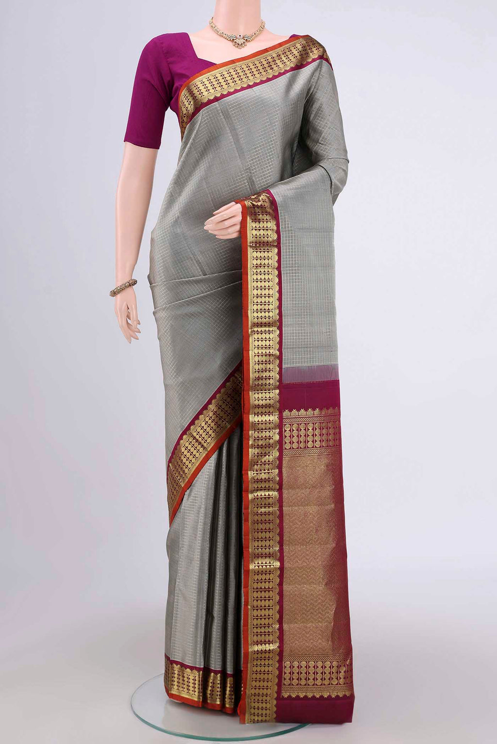 Grey Dual Tone Kanchipuram Saree with Checked design on the body and Zari Border.  displayed on a mannequin